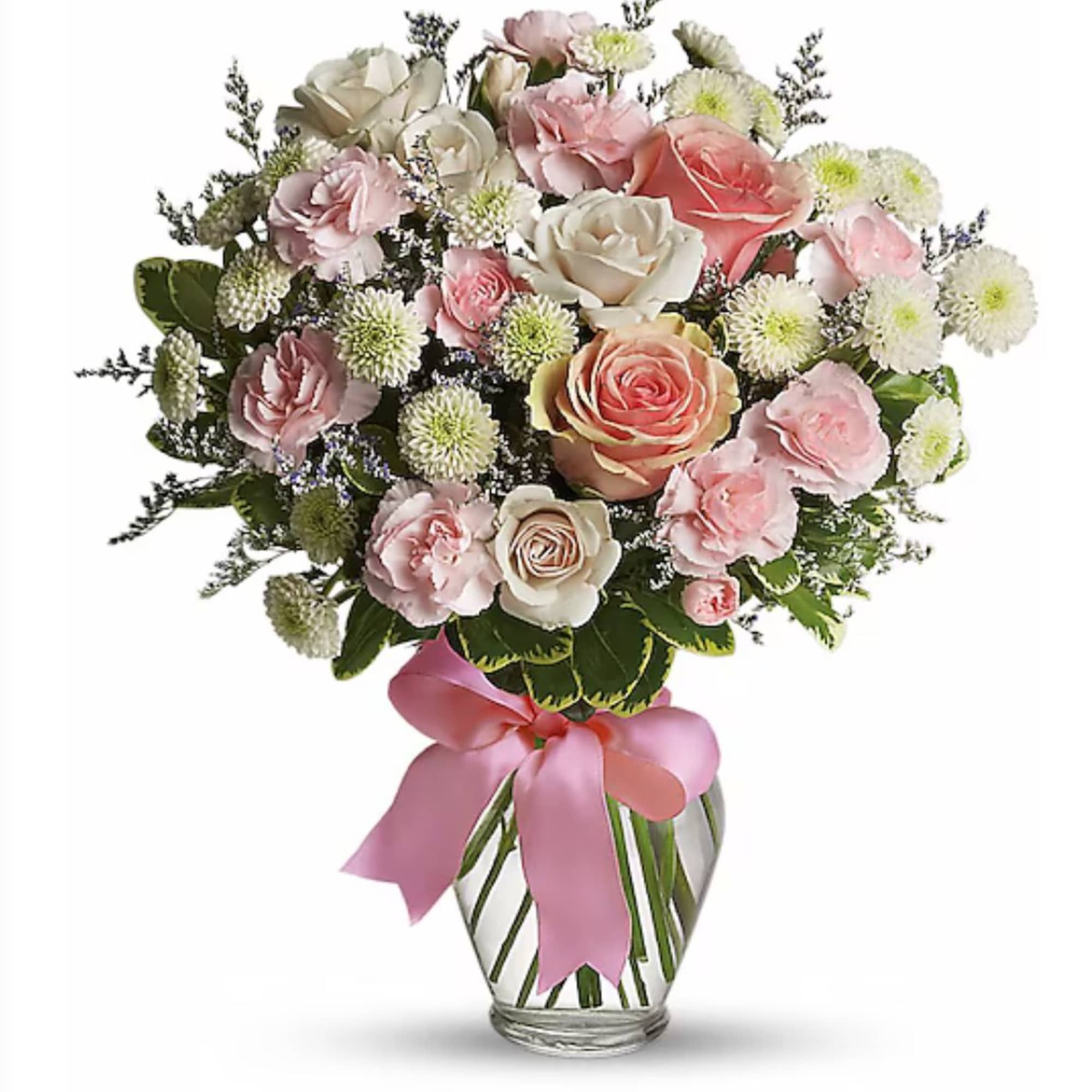 Bouquet of pink and white roses and carnations in a glass vase with a pink ribbon bow