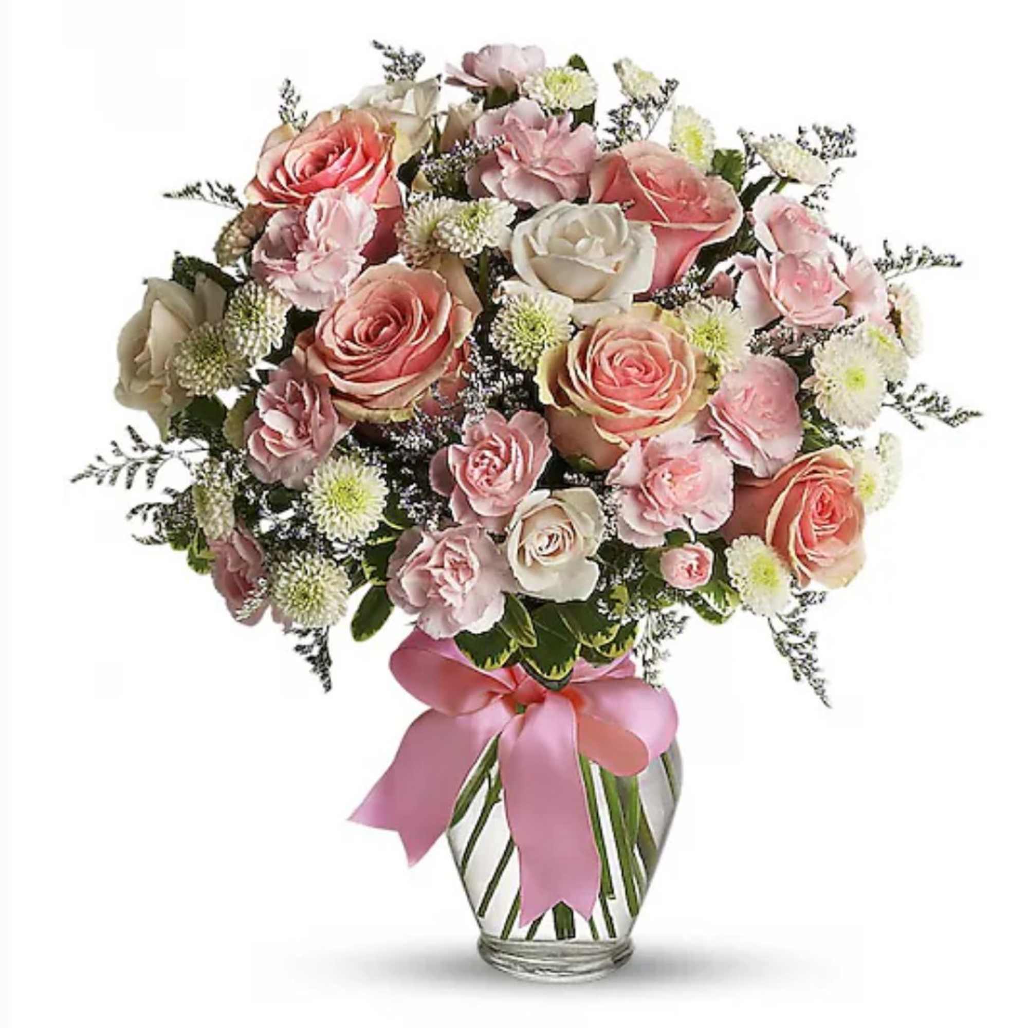 Pink and peach rose bouquet with white accent blooms in a clear vase with a pink bow