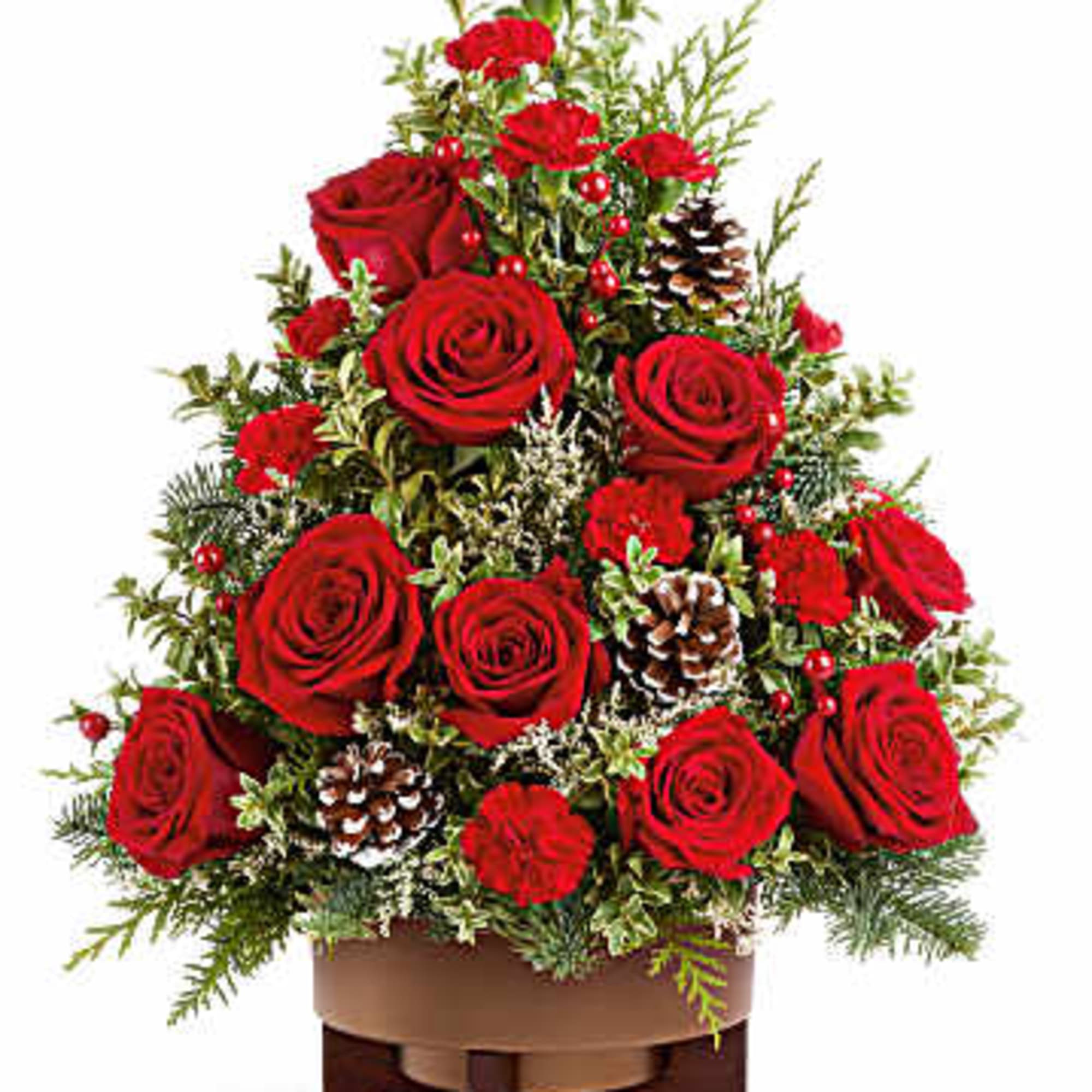 Red roses arranged in a tiered holiday centerpiece with pinecones