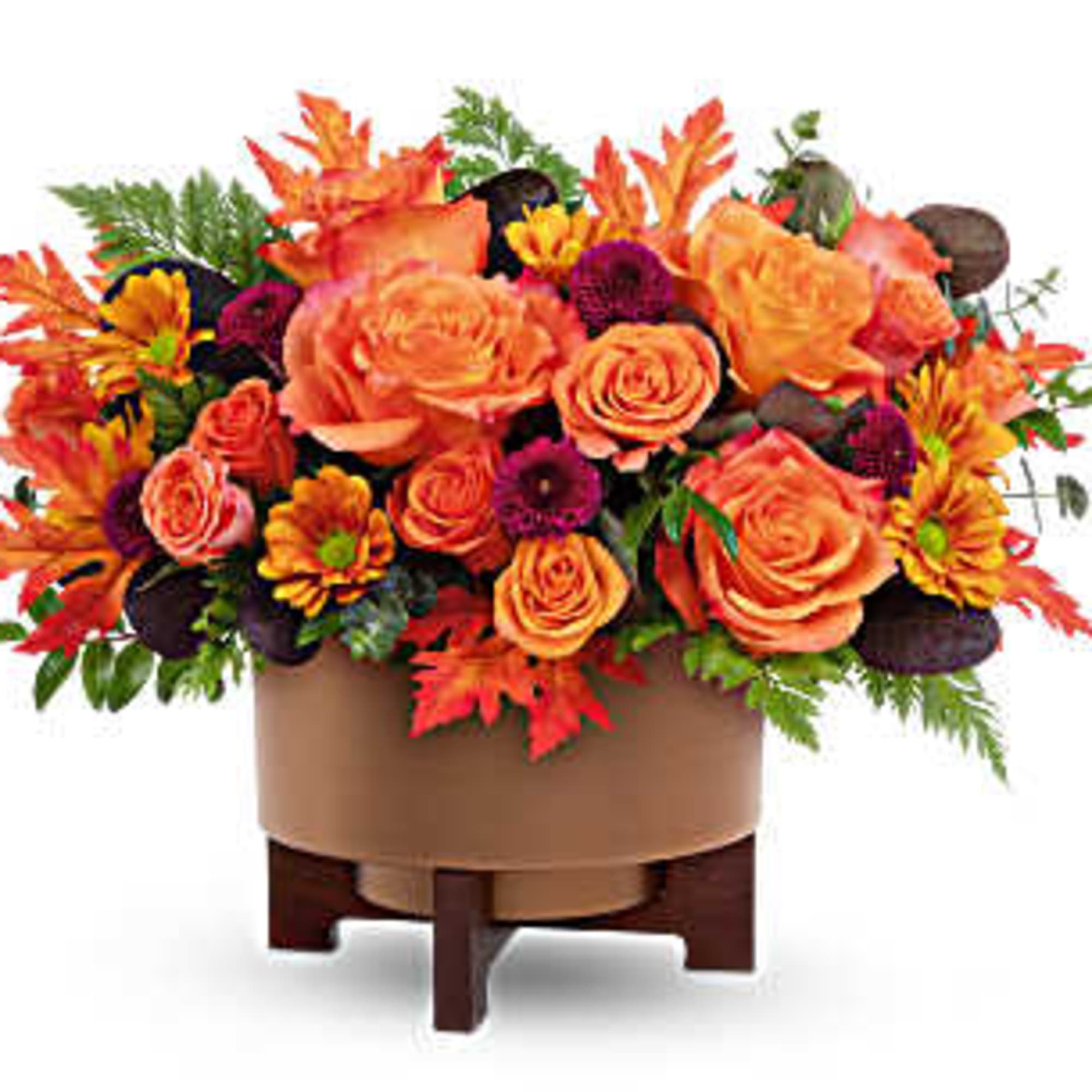 Orange and yellow floral arrangement in a round box on a stand