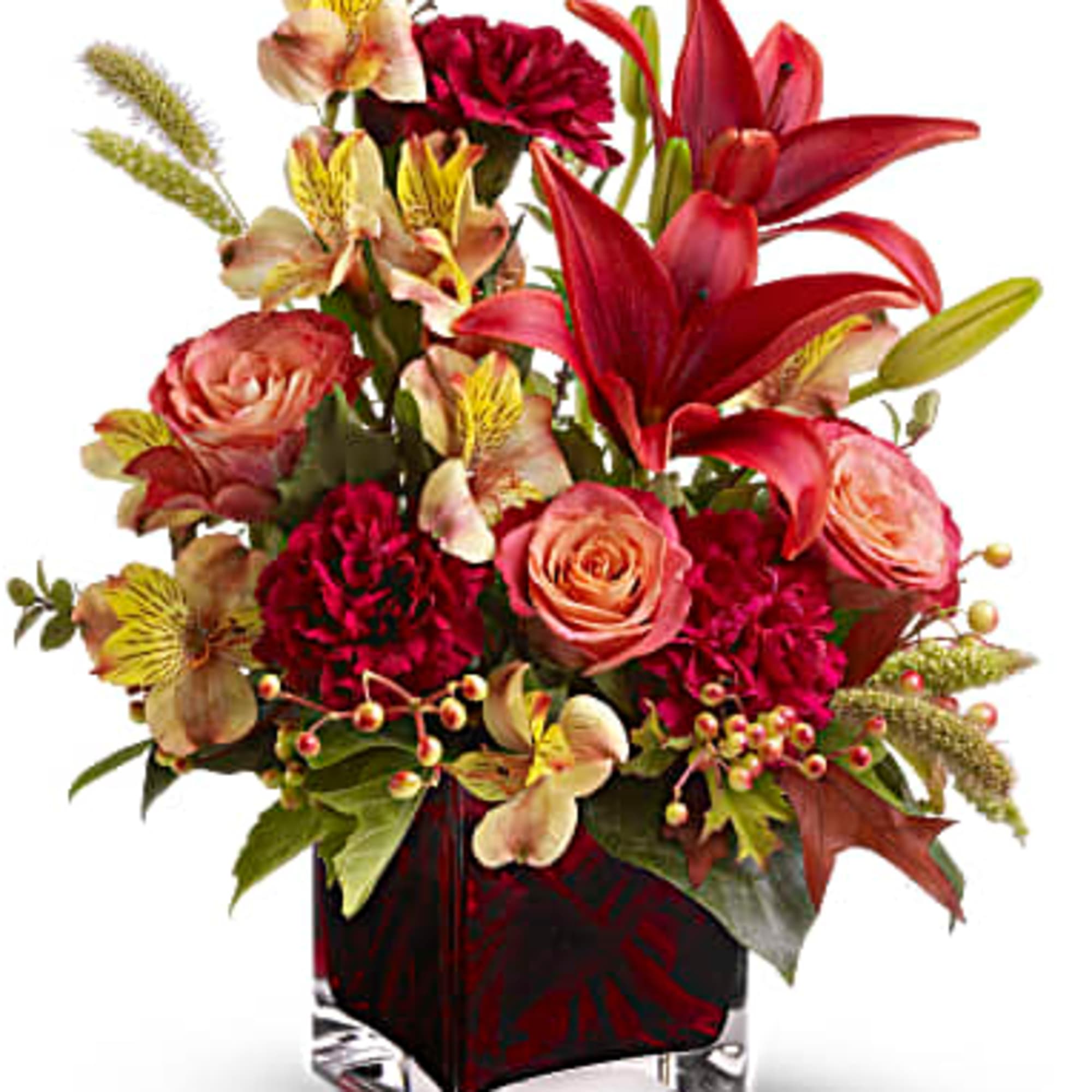 Red lilies and pink roses in a square glass vase