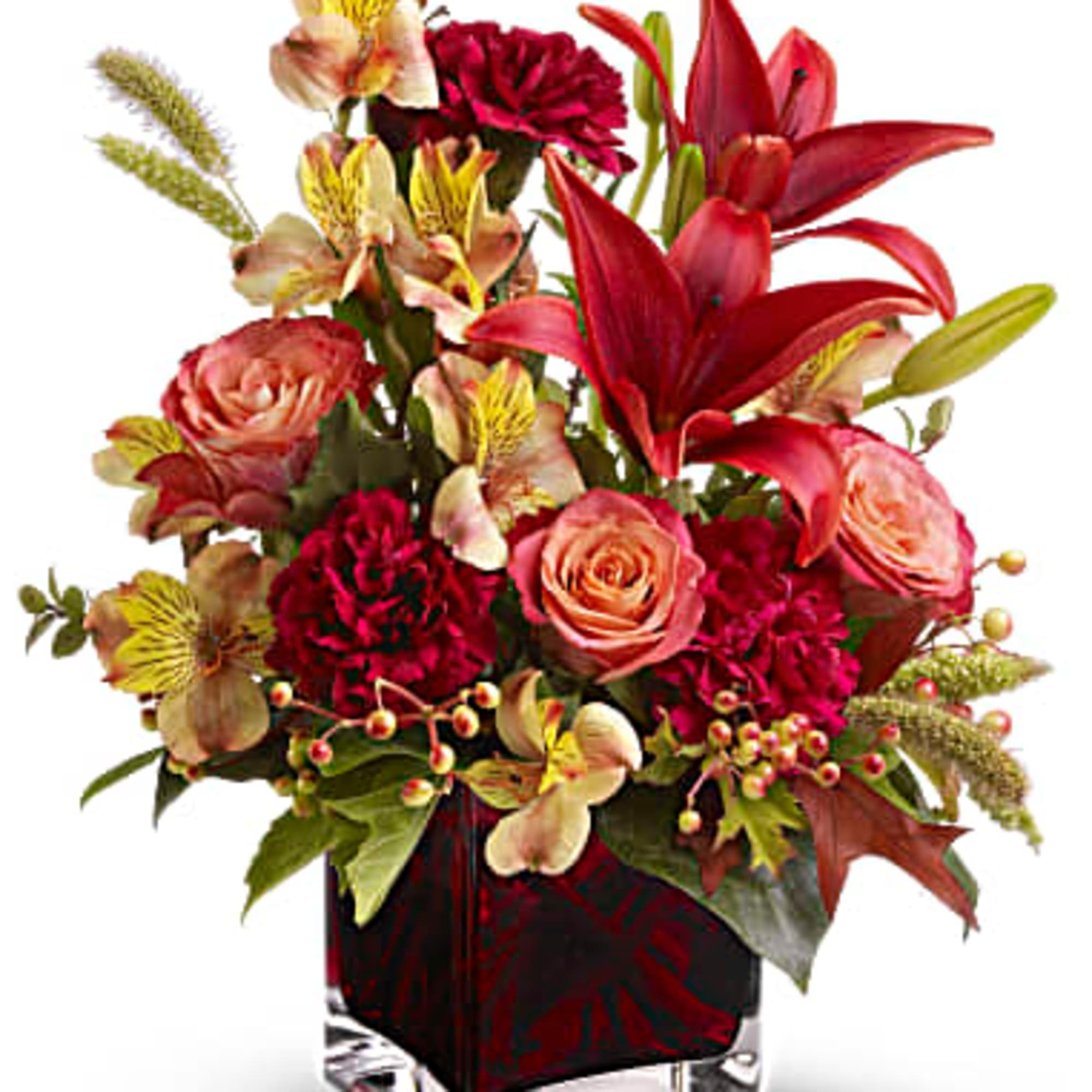 Red lilies and roses in a square glass vase