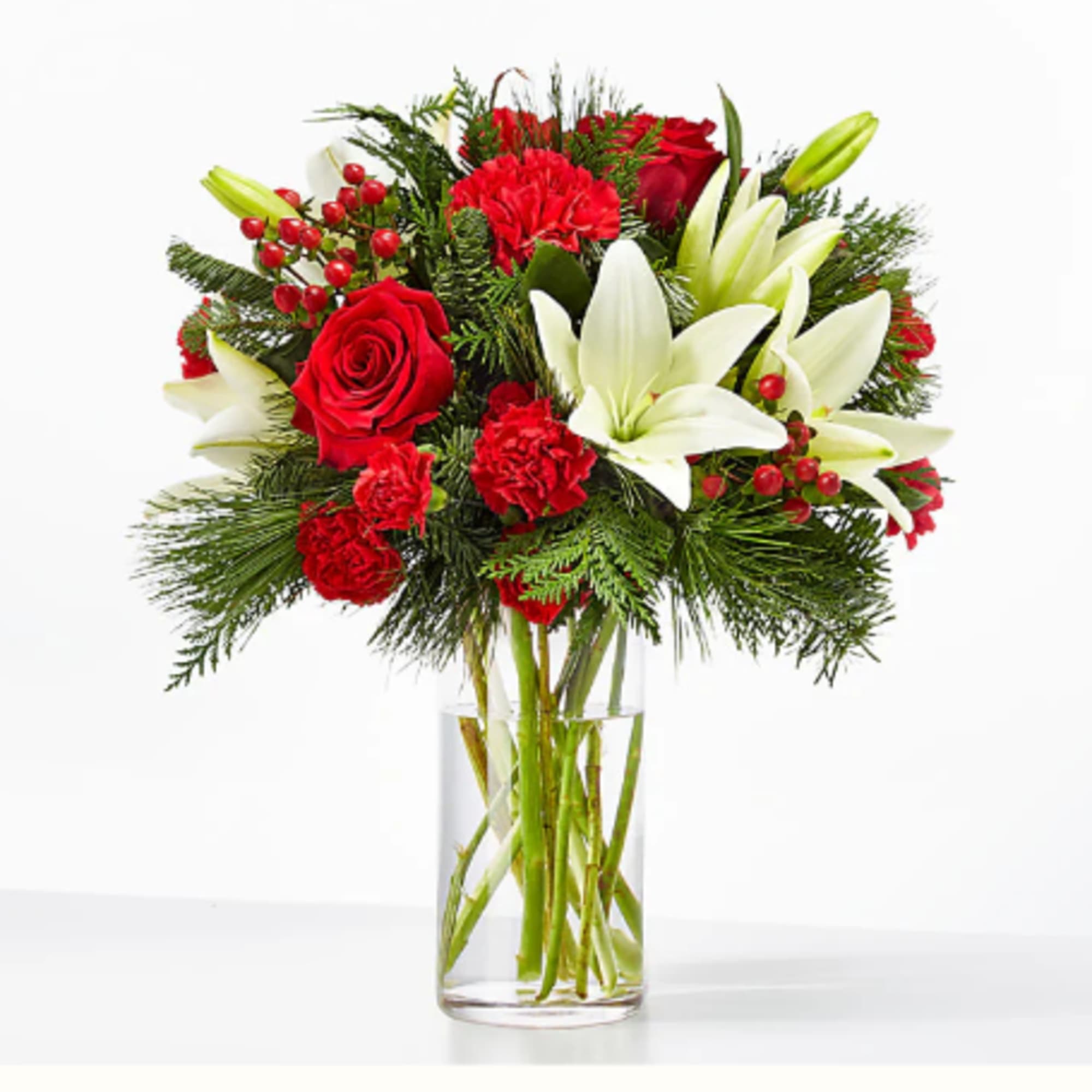 Red roses and white lilies arranged in a clear glass vase