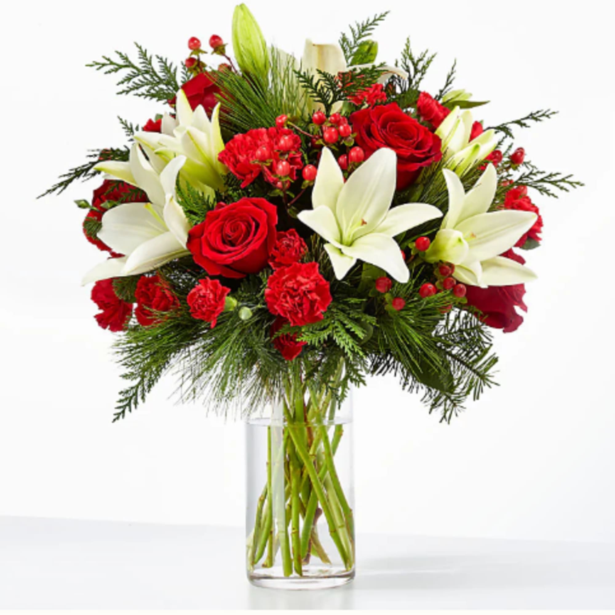 Red roses and white lilies in a clear glass vase