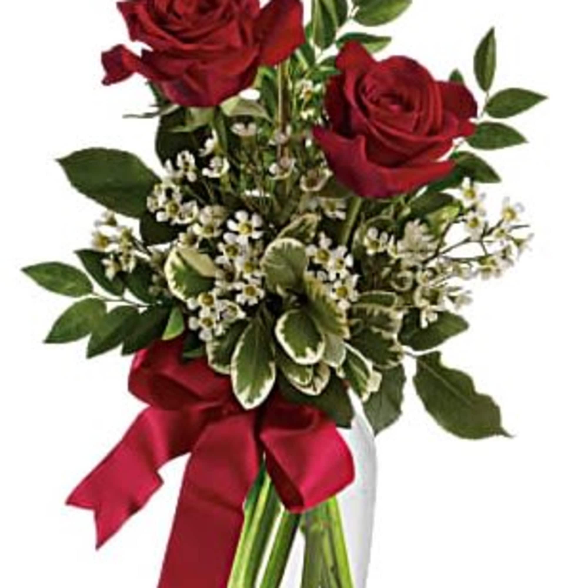 Red roses in a clear glass vase with a red ribbon