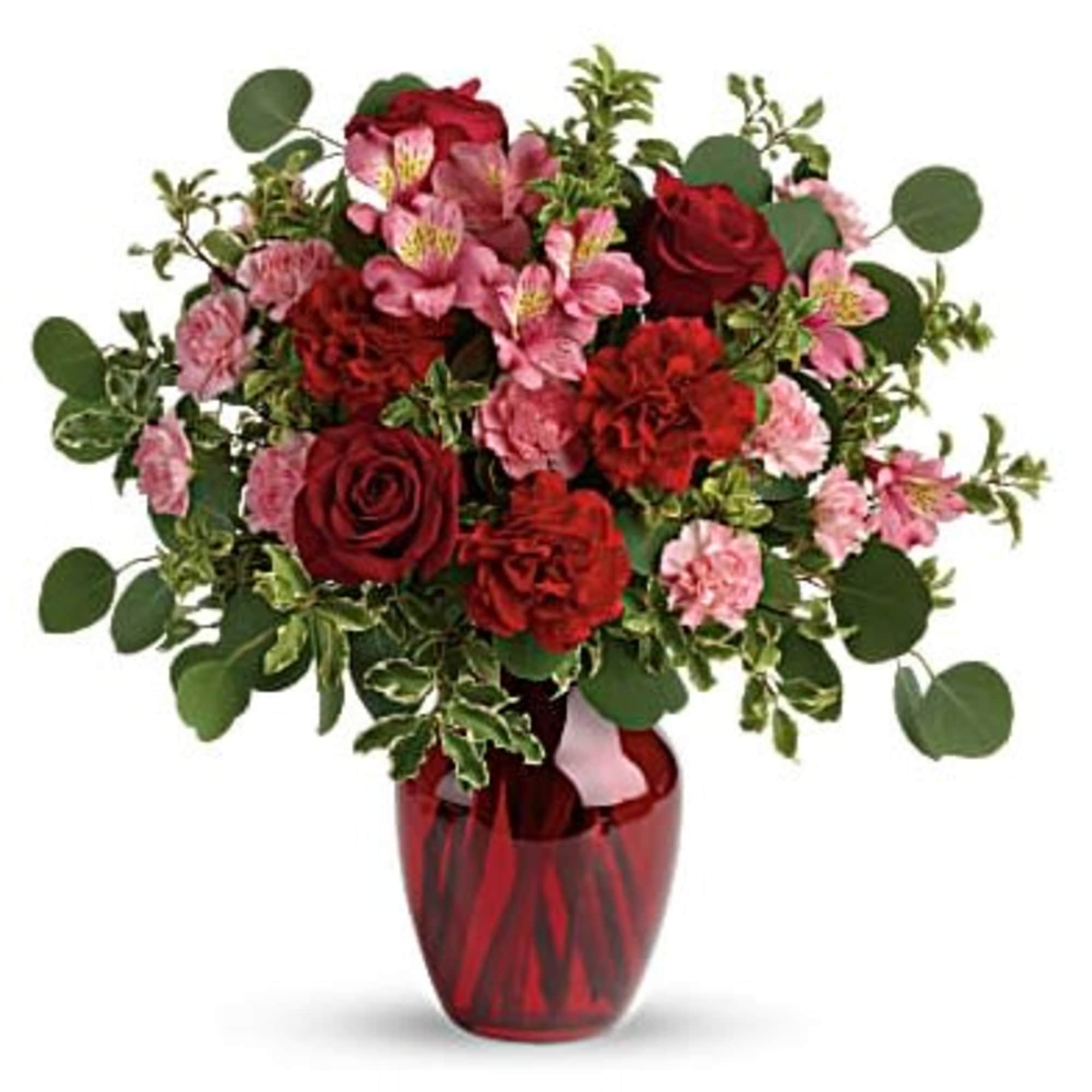 Red and pink flower bouquet in a red glass vase