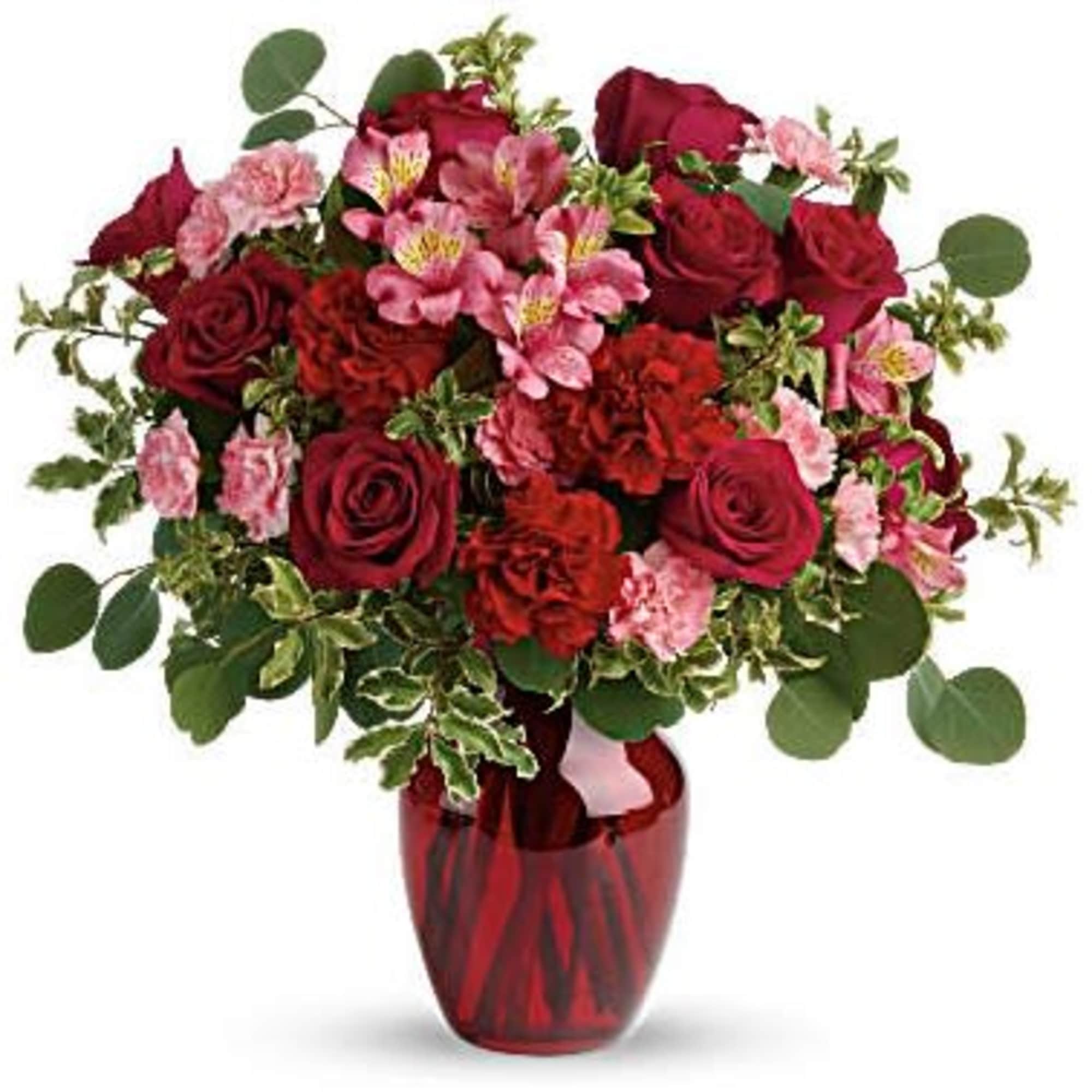 Red roses and pink flowers arranged in a red vase