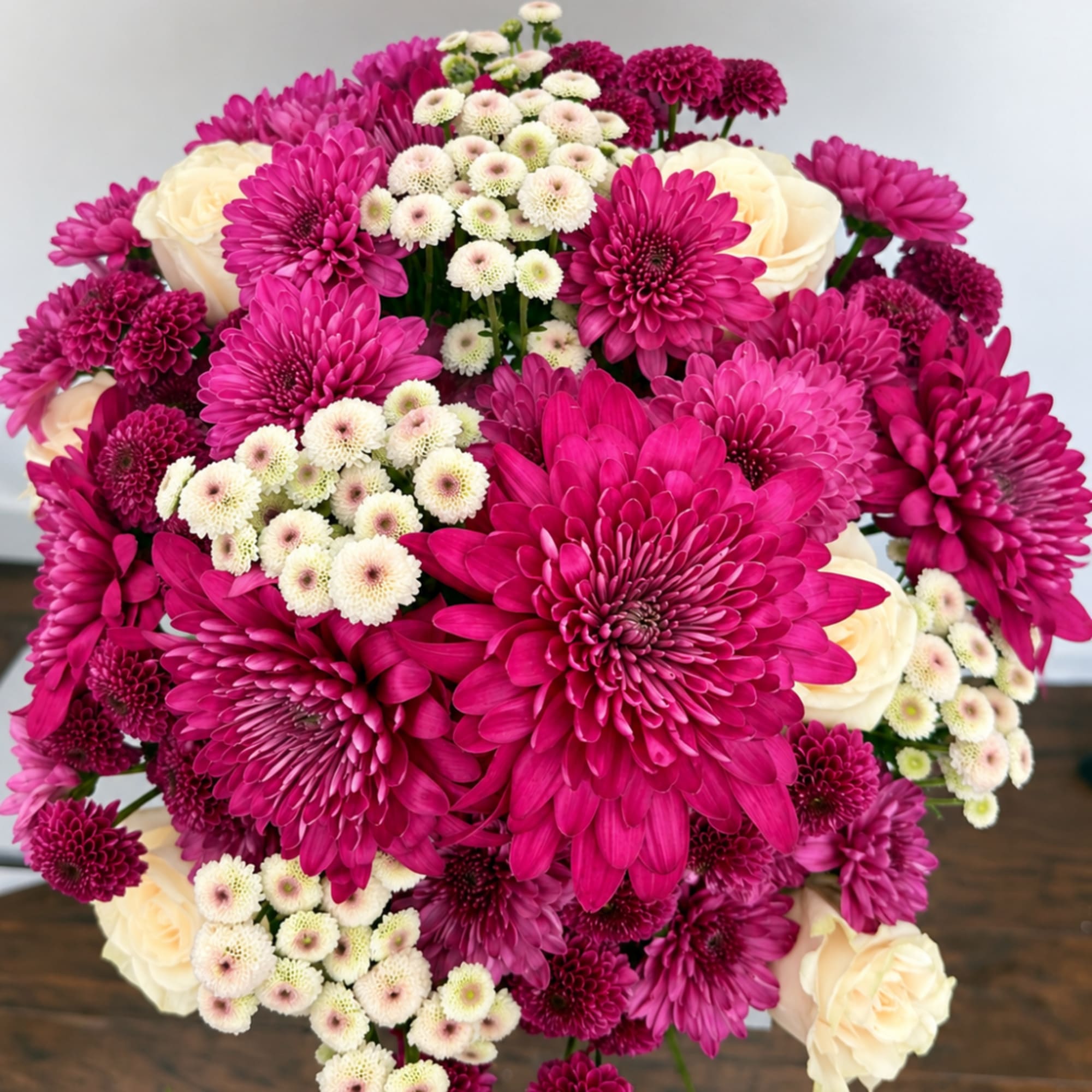 Bouquet of magenta chrysanthemums and cream roses