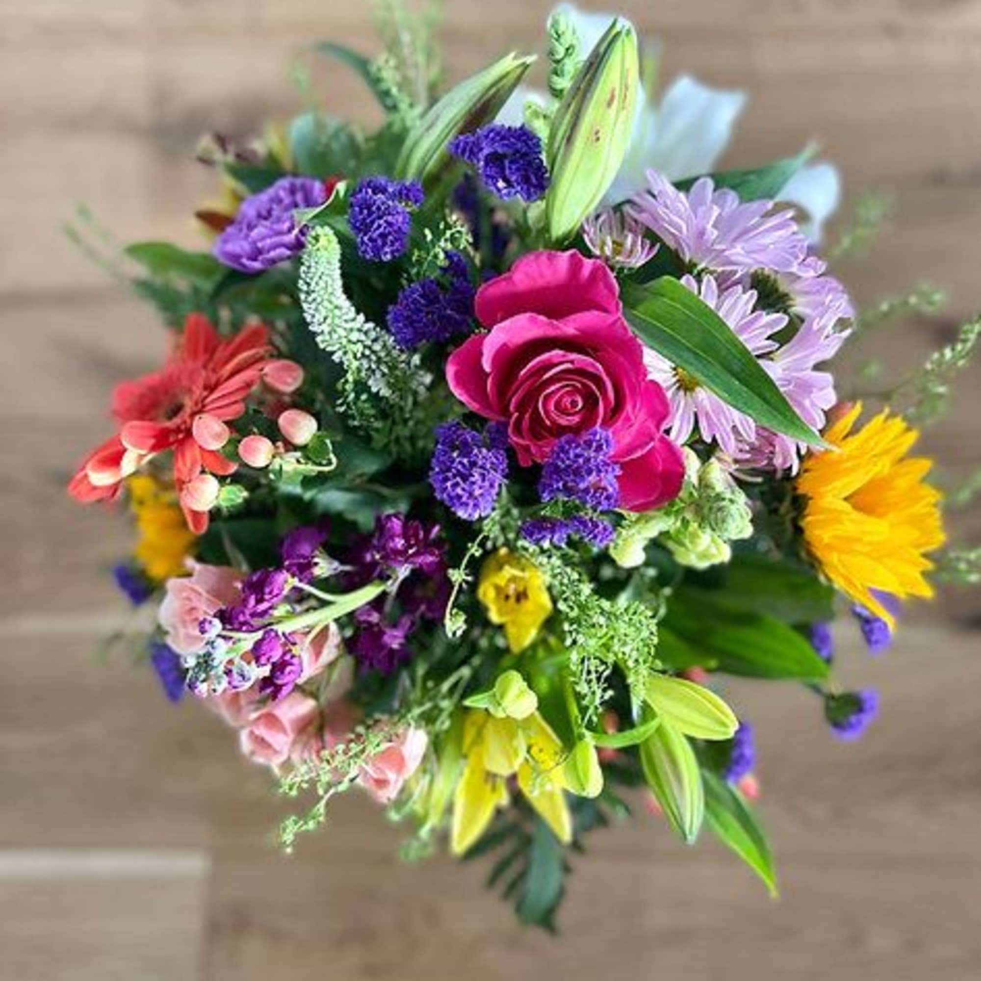 Colorful mixed bouquet with roses, lilies, and daisies