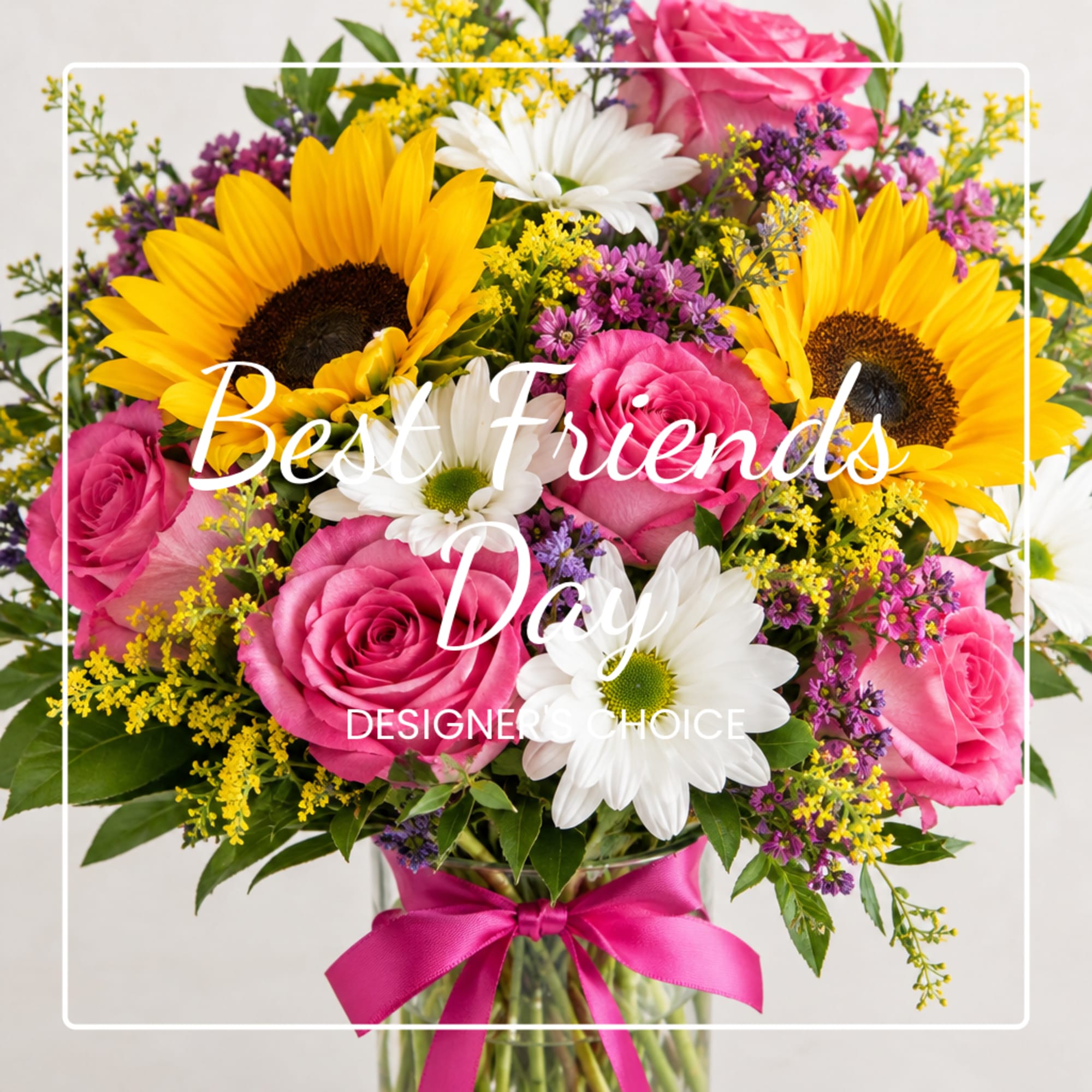 Bouquet of pink roses, sunflowers, and white daisies in a glass vase