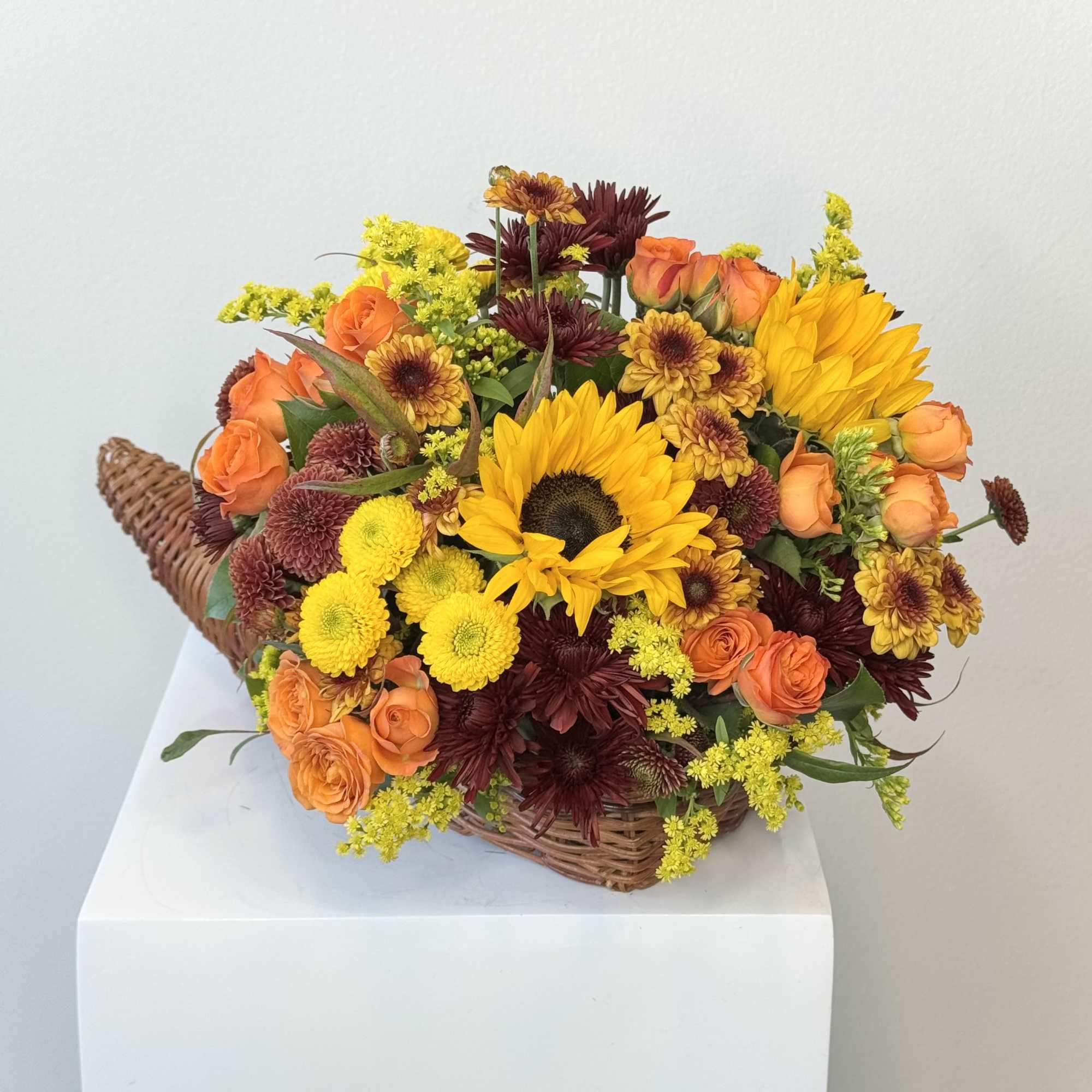 Basket arrangement with sunflowers, orange roses, and chrysanthemums