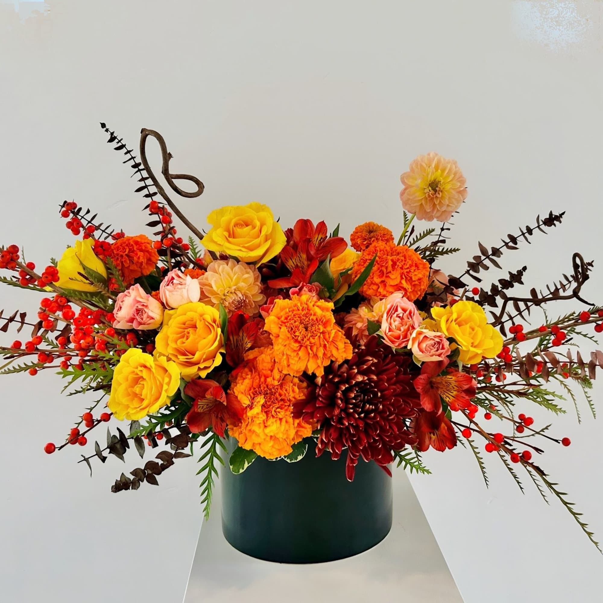 This arrangement radiates warmth and brightness &mdash; like a golden harvest catching