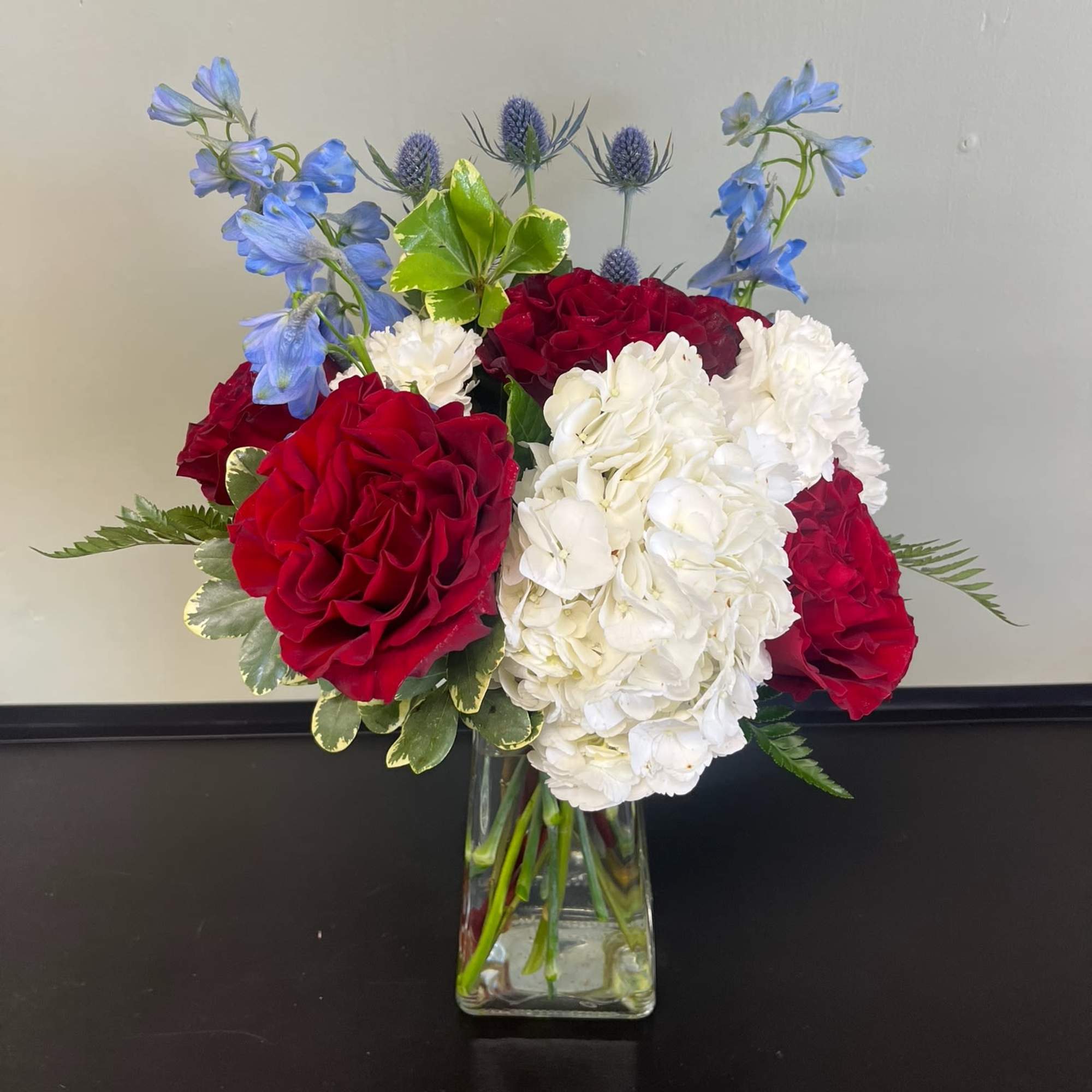 Bouquet of red and white flowers in a clear glass vase