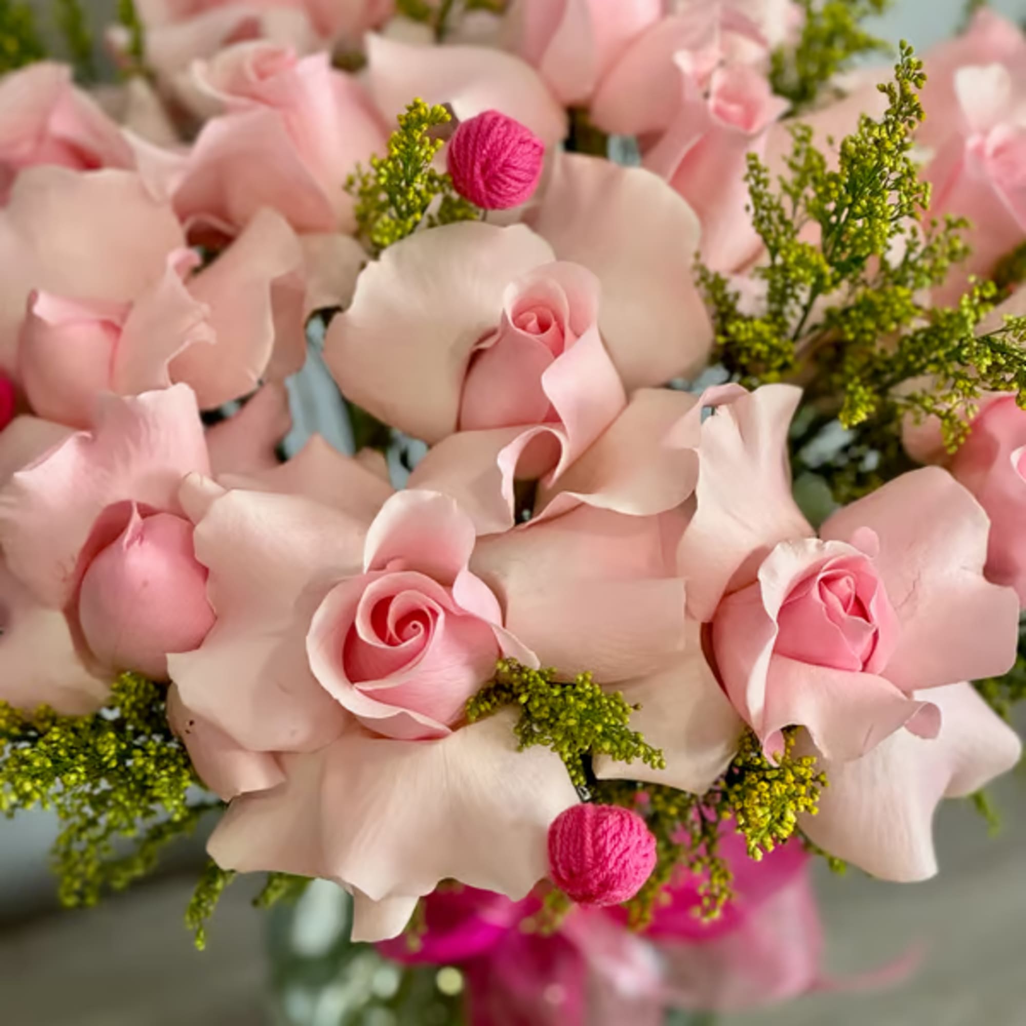 Bouquet of pale pink roses with bright pink accents