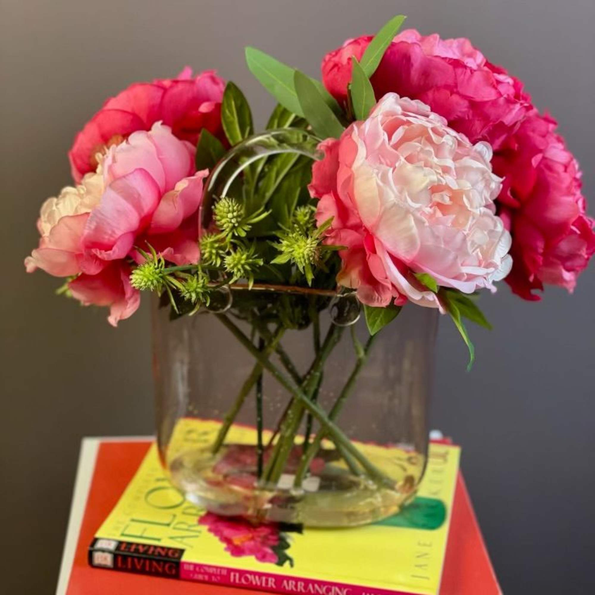 Pink peonies arranged in a clear glass vase