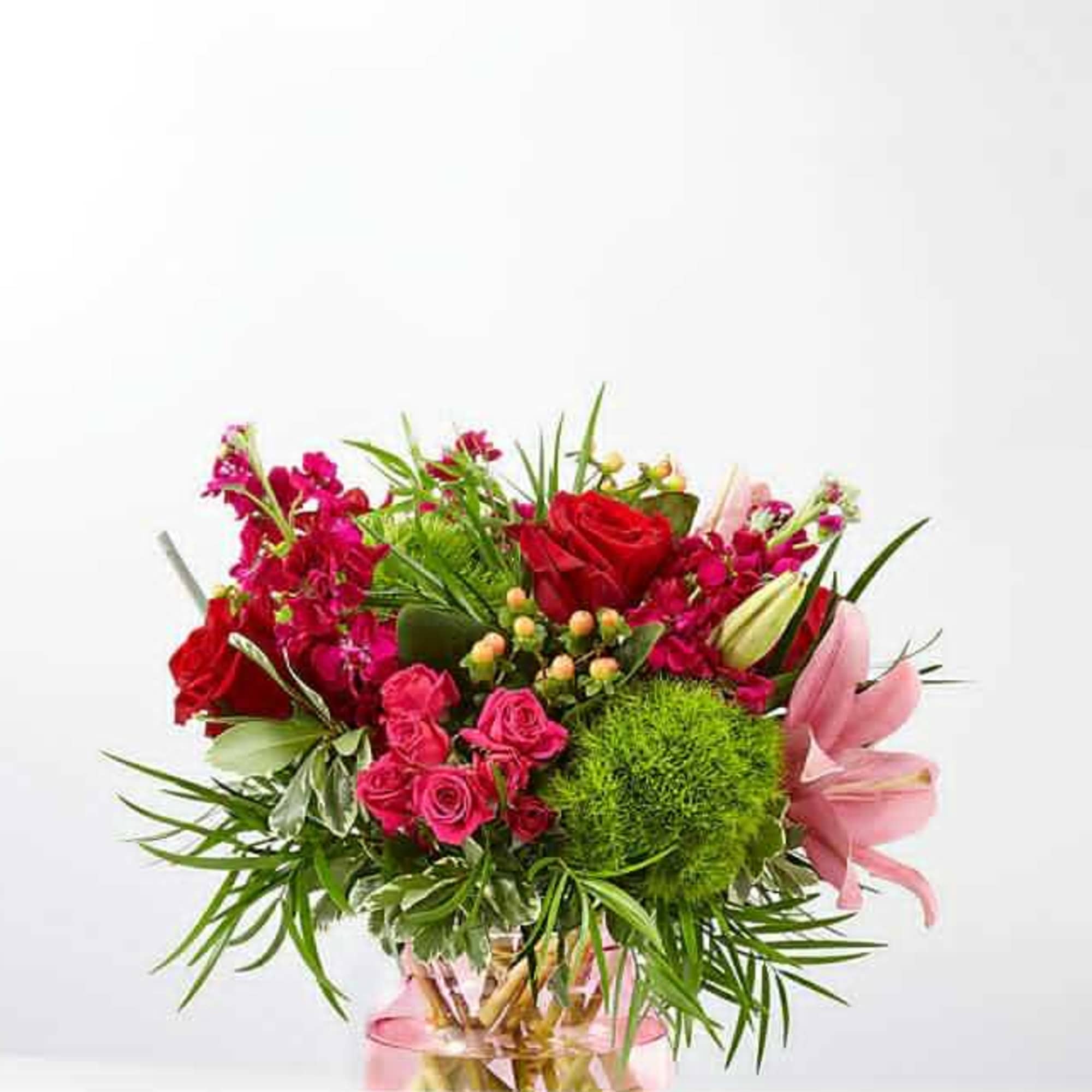Bouquet of red and pink flowers in a glass vase