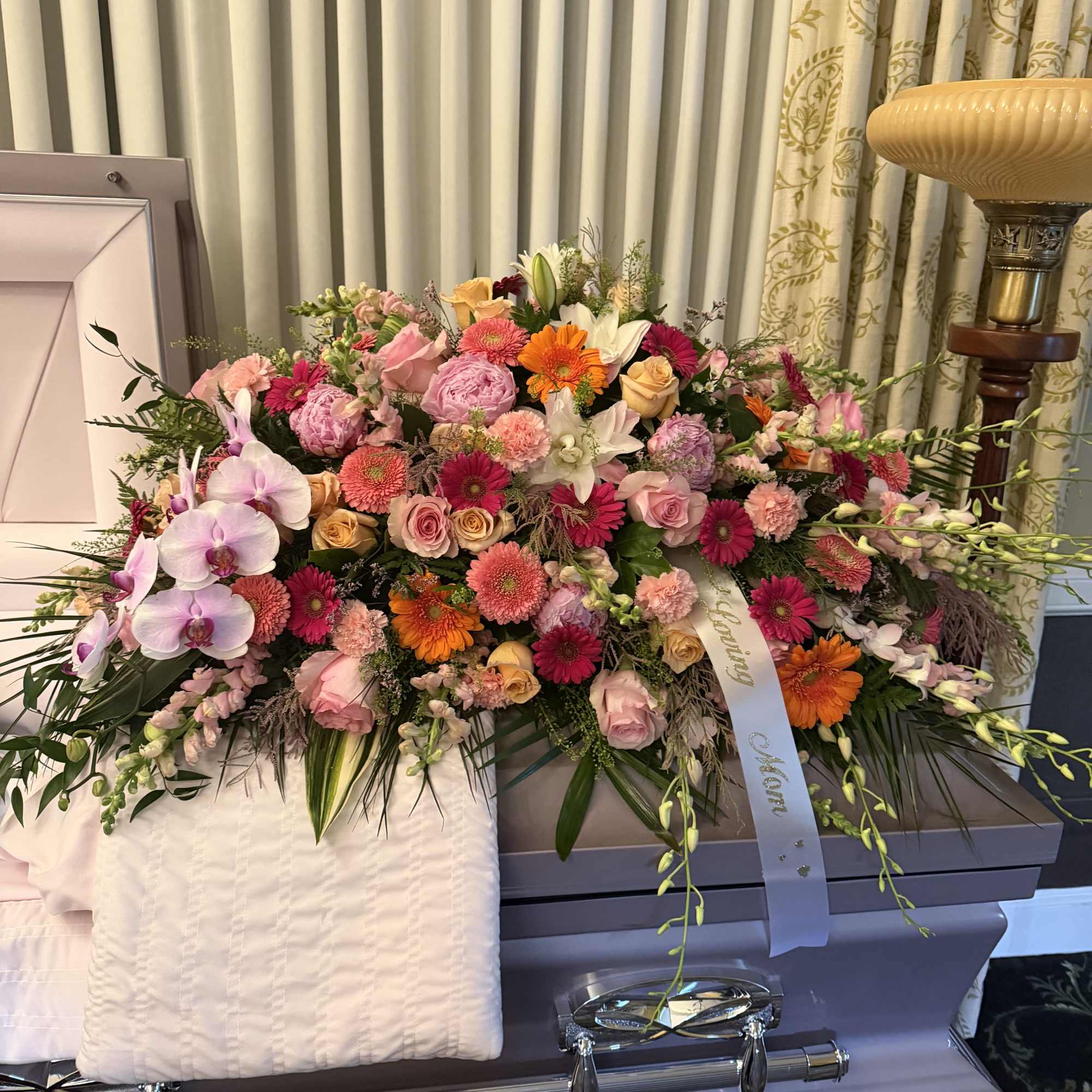 A beautiful and heartfelt tribute featuring roses, orchids, lilies, peonies, gerbera daisies, photo 2 of 2
