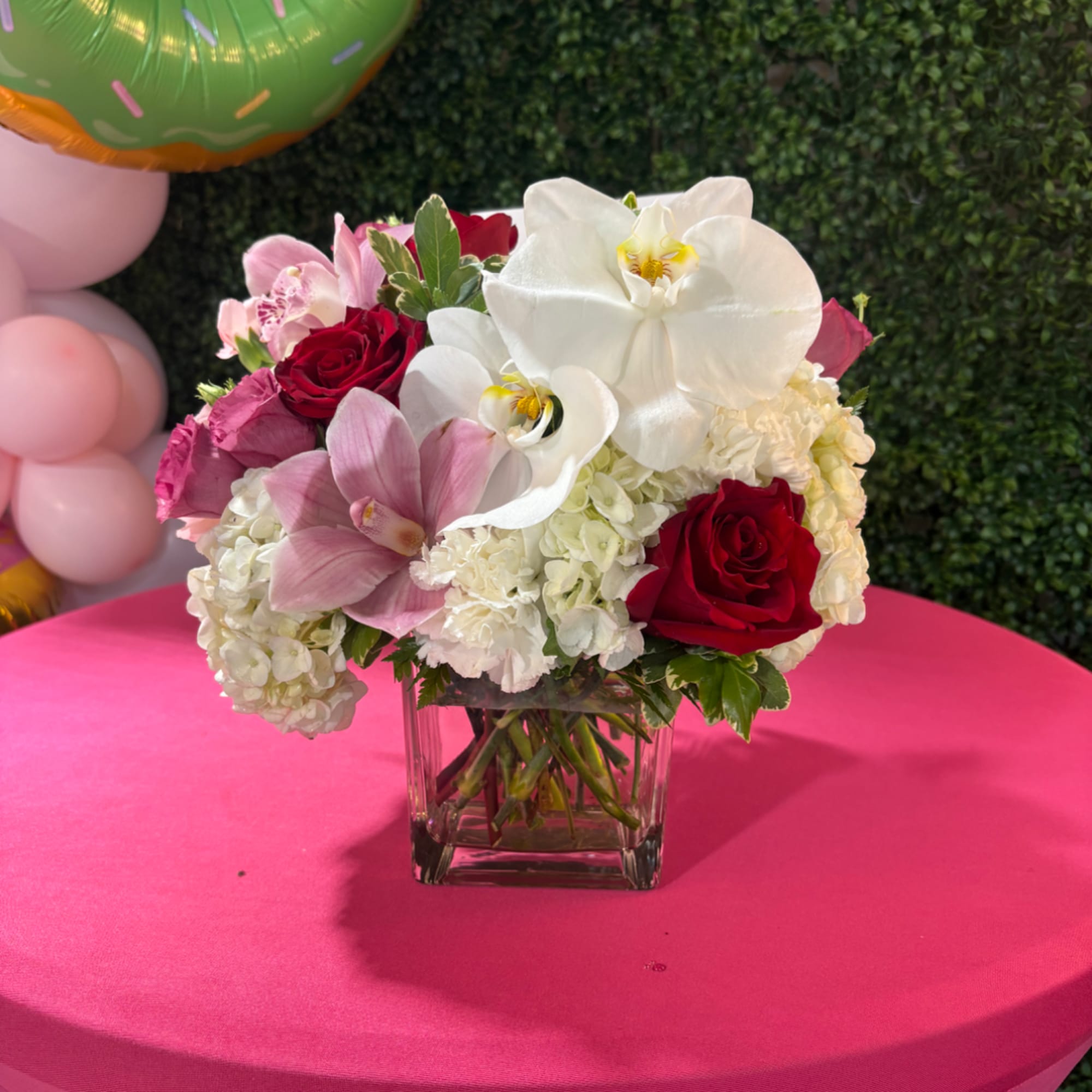 Pink and white floral arrangement in a clear square vase, photo 2 of 2
