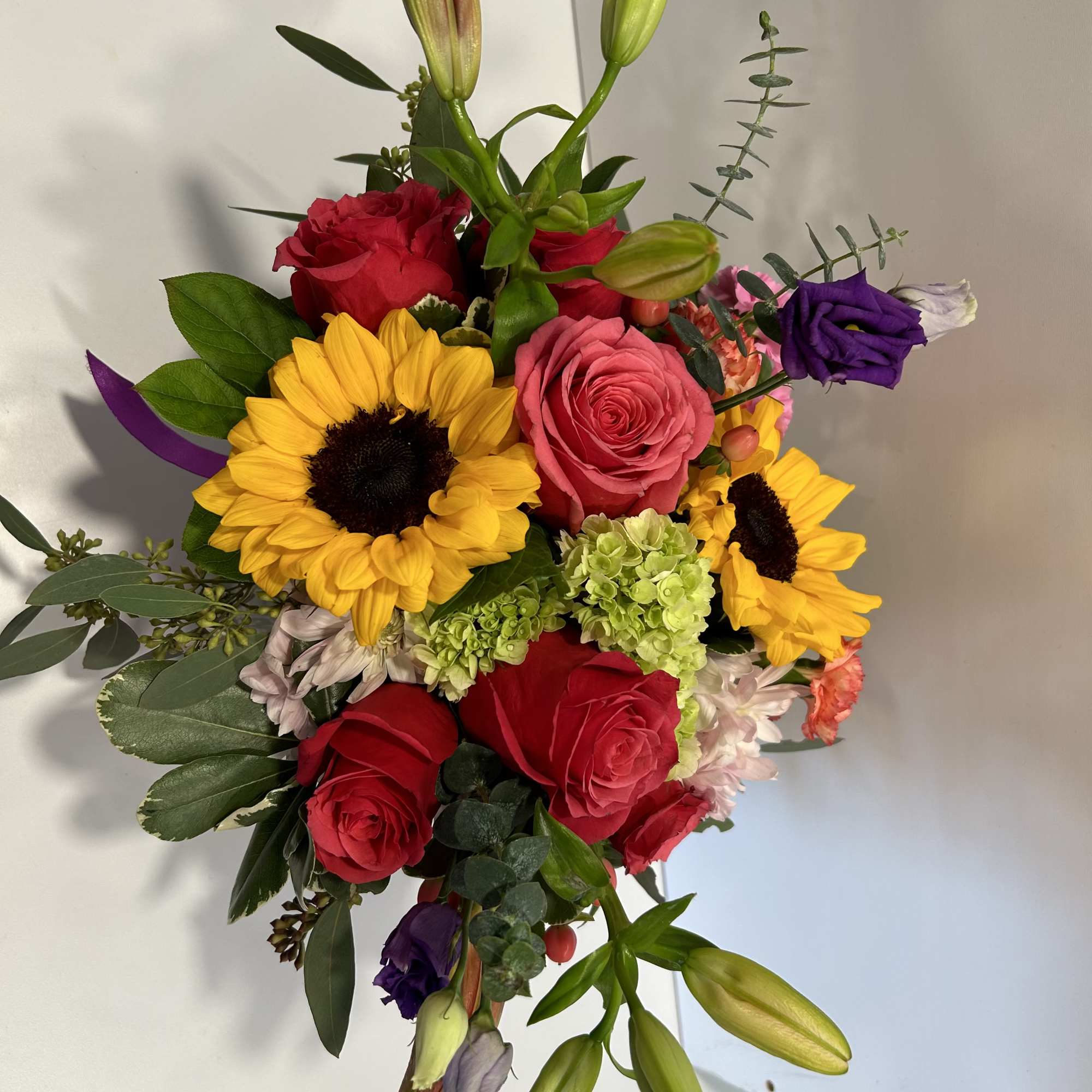 Mixed bouquet with roses, sunflowers, and lily buds