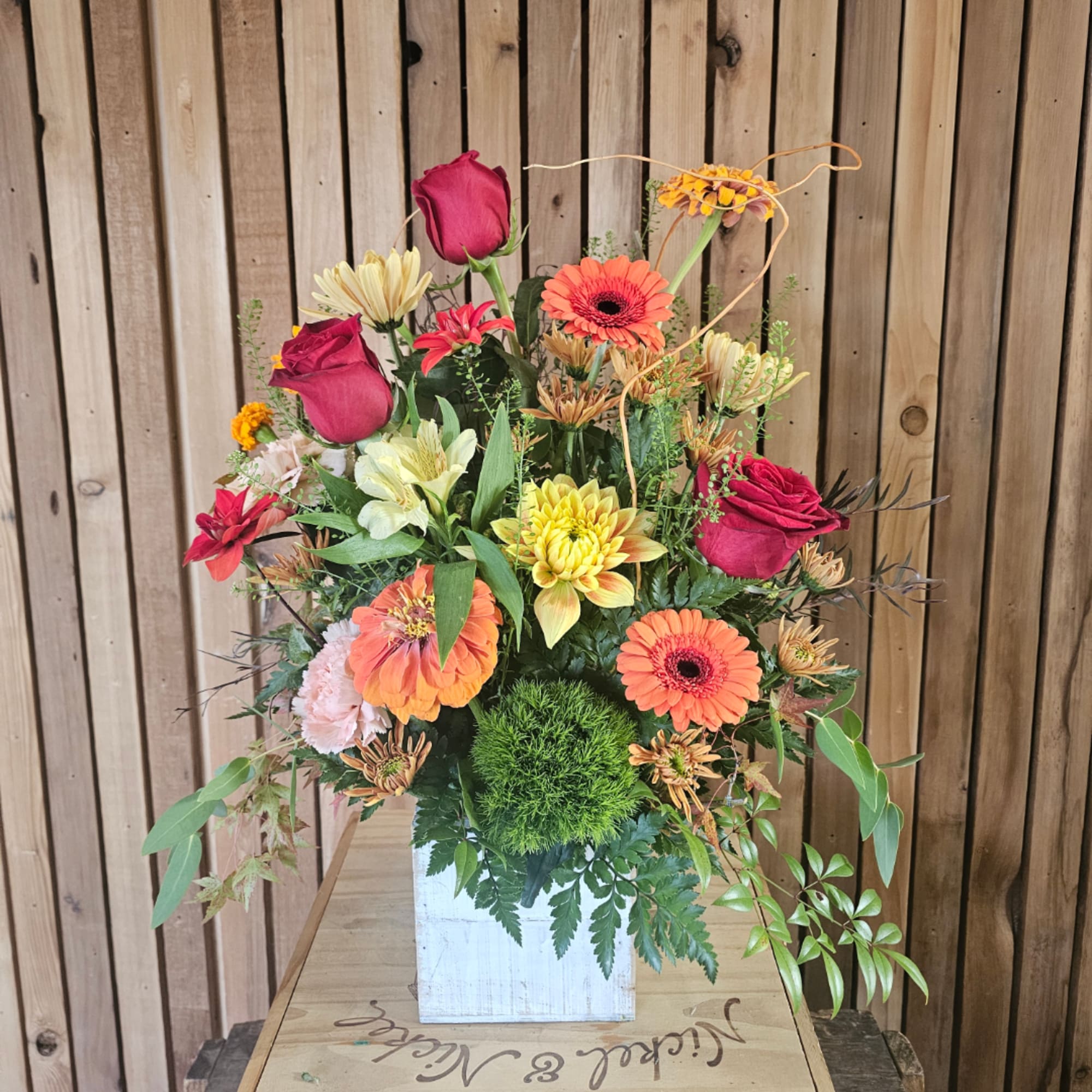 Mixed bouquet of roses, gerbera daisies, and chrysanthemums in a white box