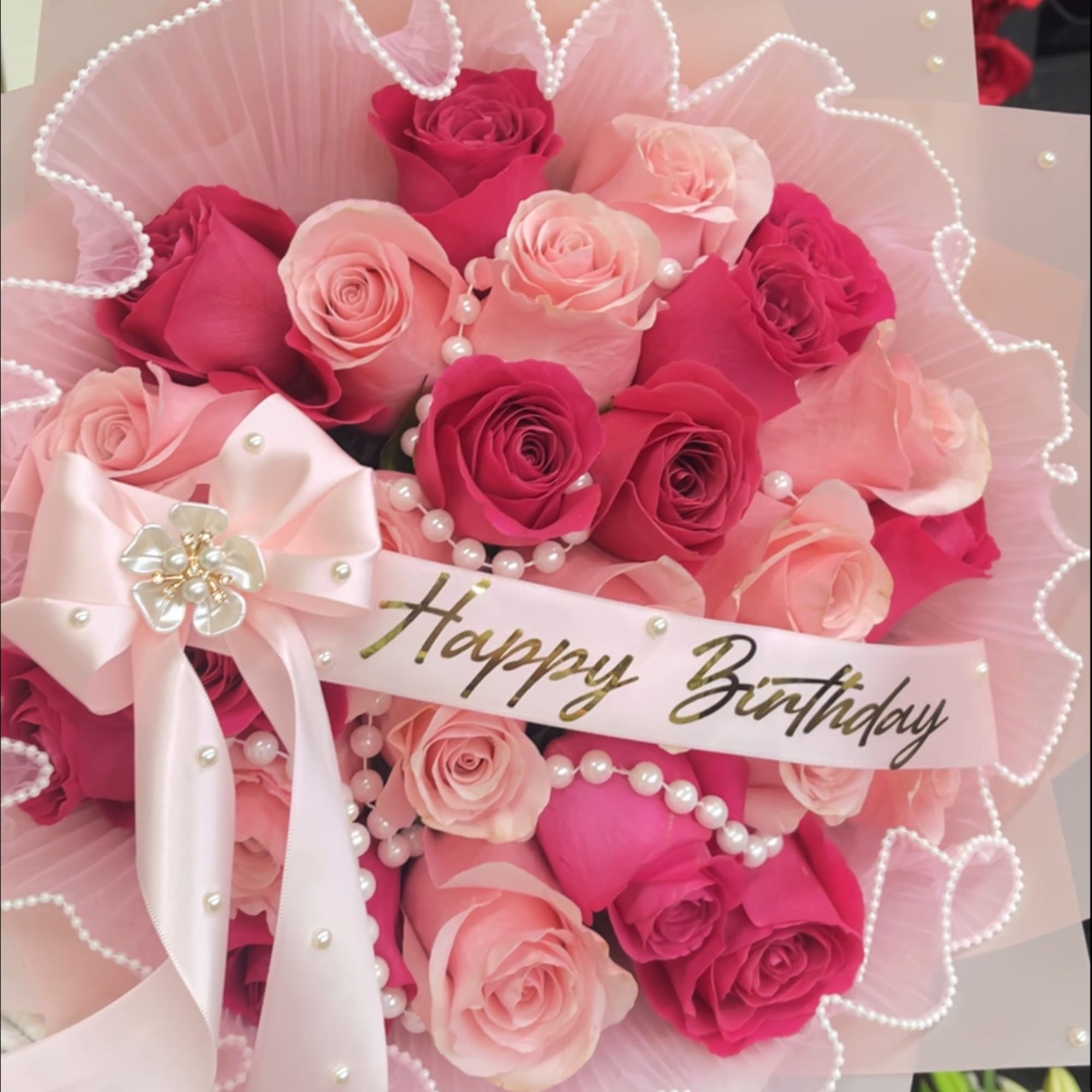 Pink and hot pink rose bouquet with pearls, bow, and a Happy Birthday ribbon.
