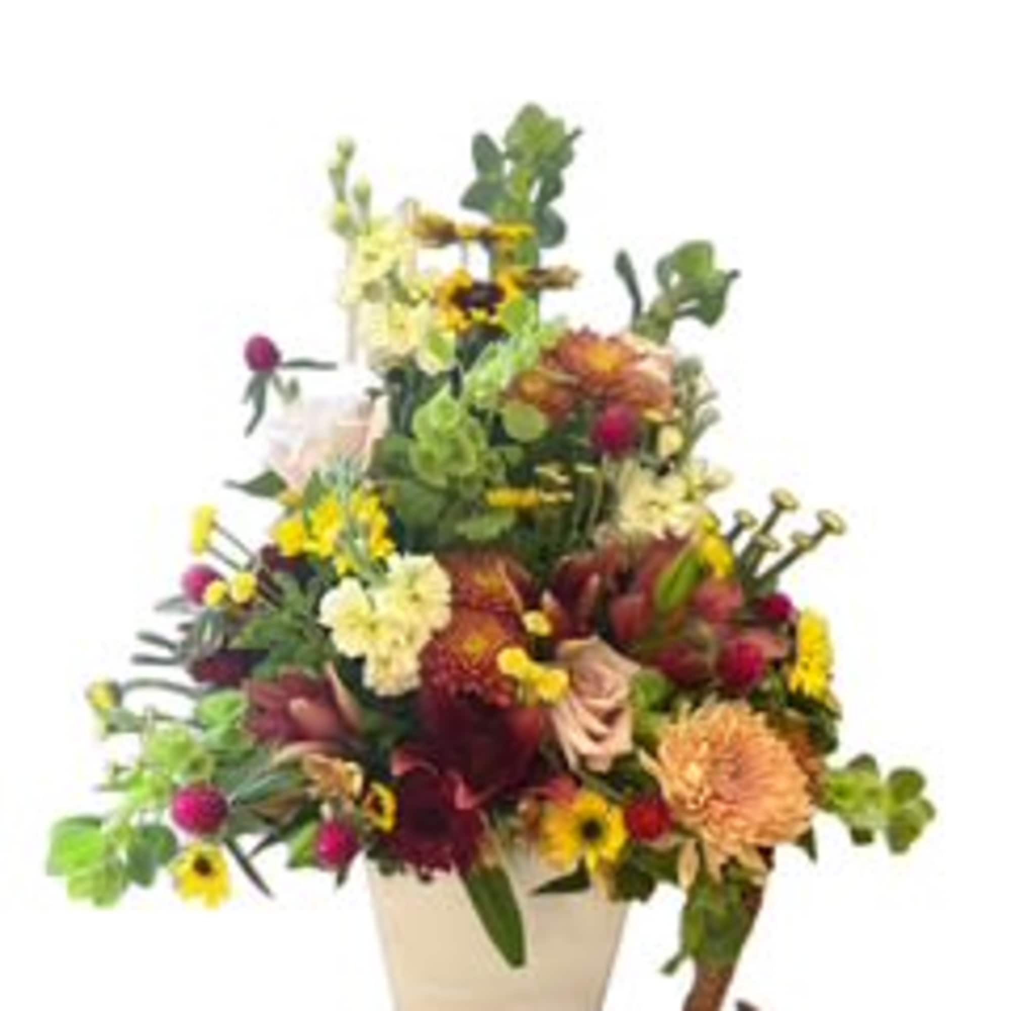 Colorful mixed flower arrangement in a white vase