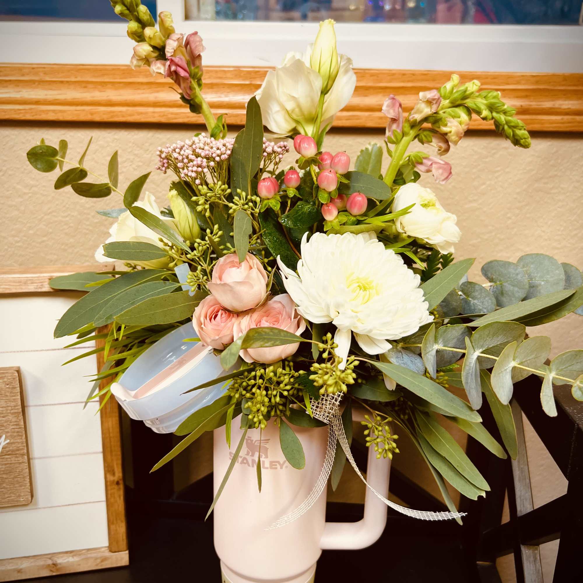 Mixed bouquet in a pink tumbler with white and pink flowers