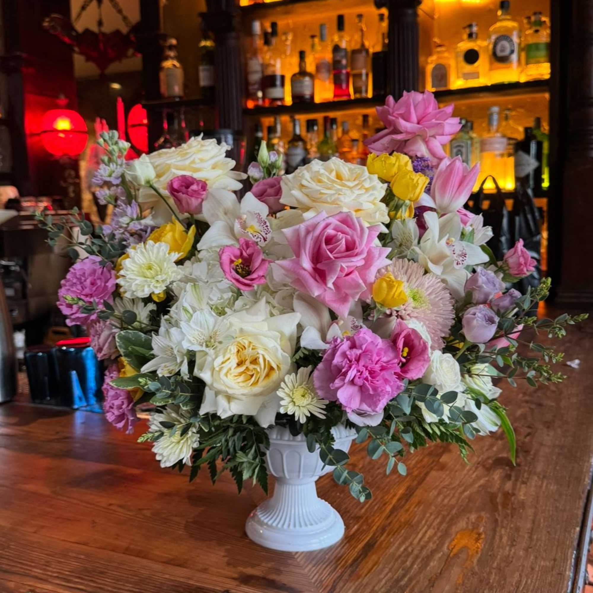 Beautiful mix of colorful florals in urn. Perfect as a gift or