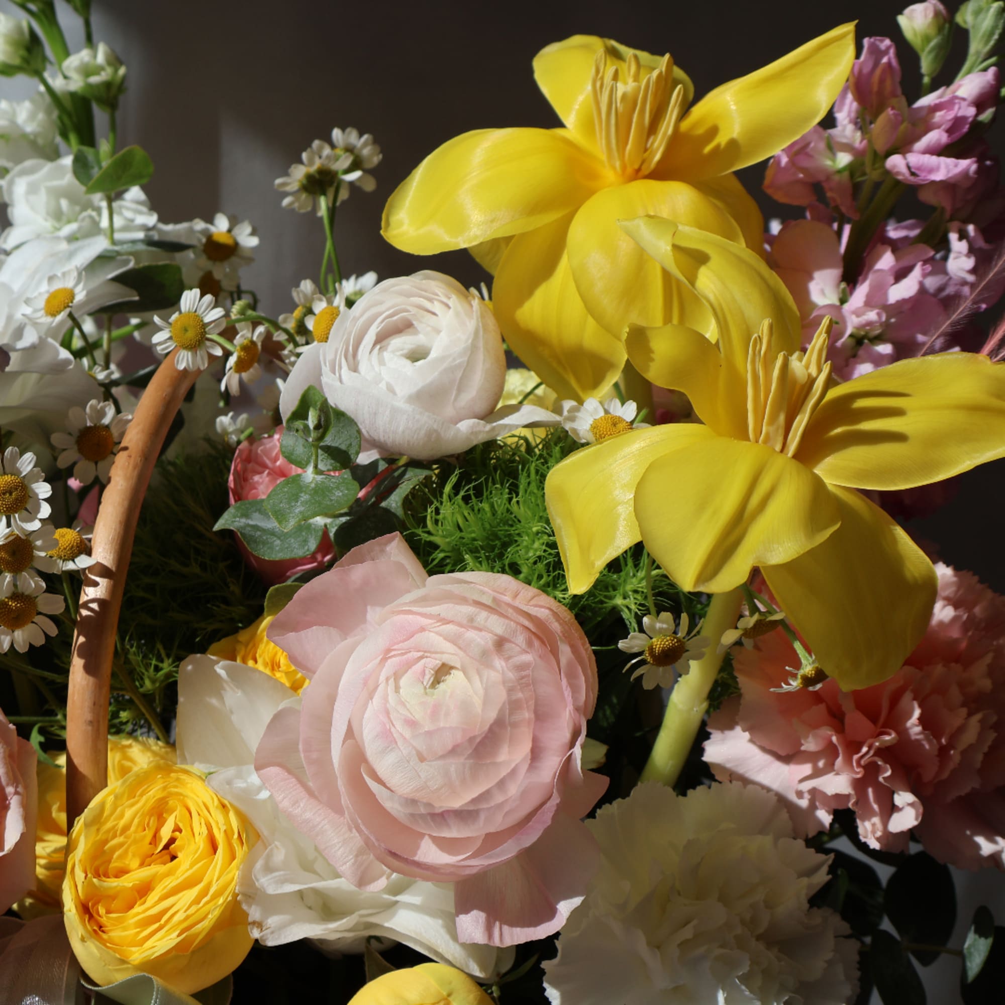 Basket of mixed flowers with large yellow blooms and pink and white blossoms