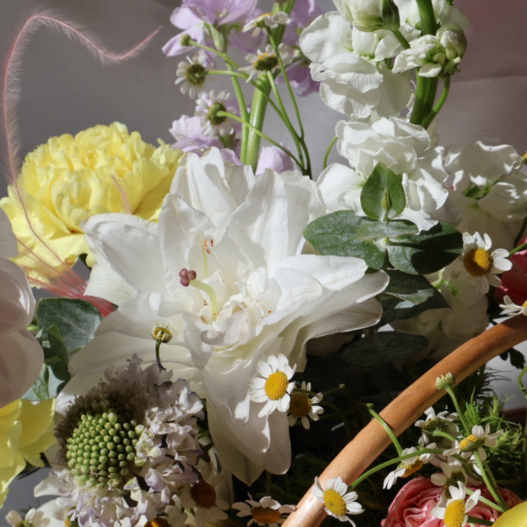 Mixed bouquet with white lilies, yellow blooms, and small daisies