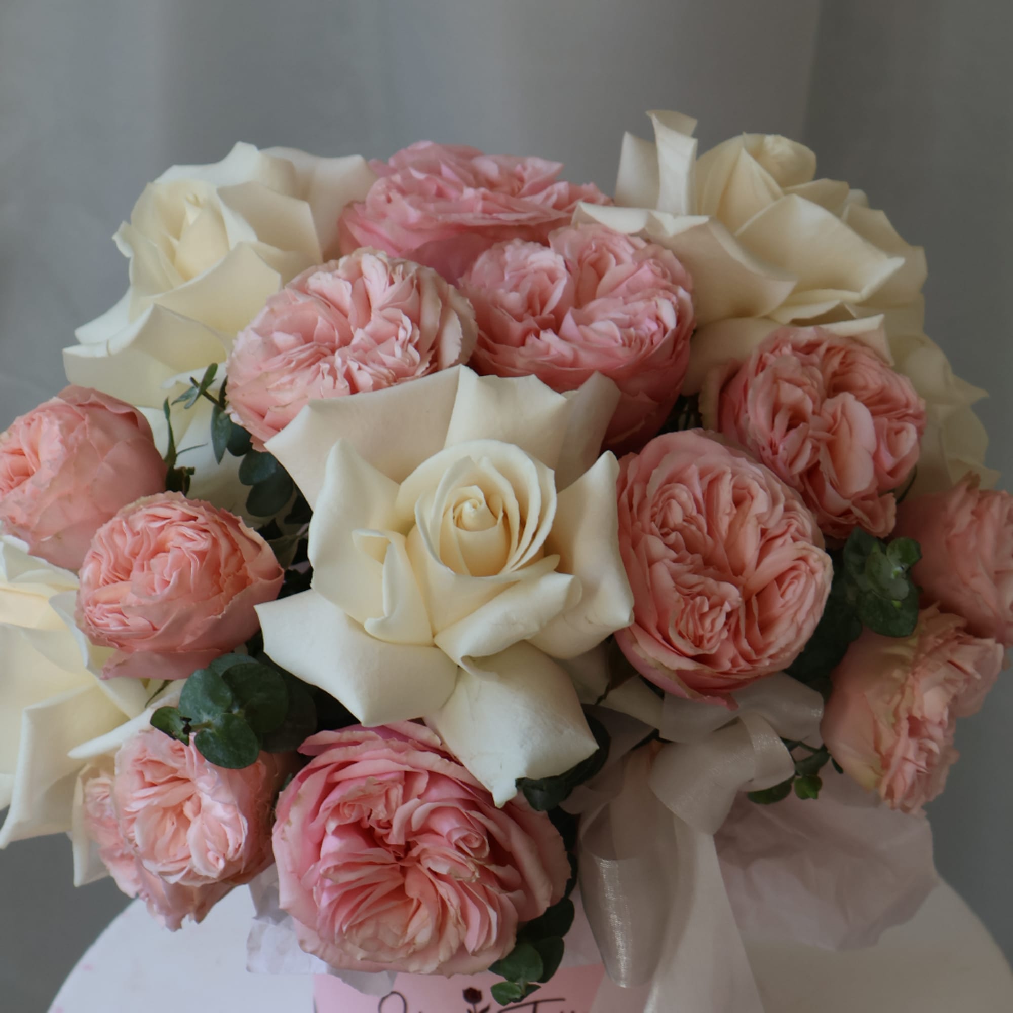 Bouquet of pink and white roses with soft greenery