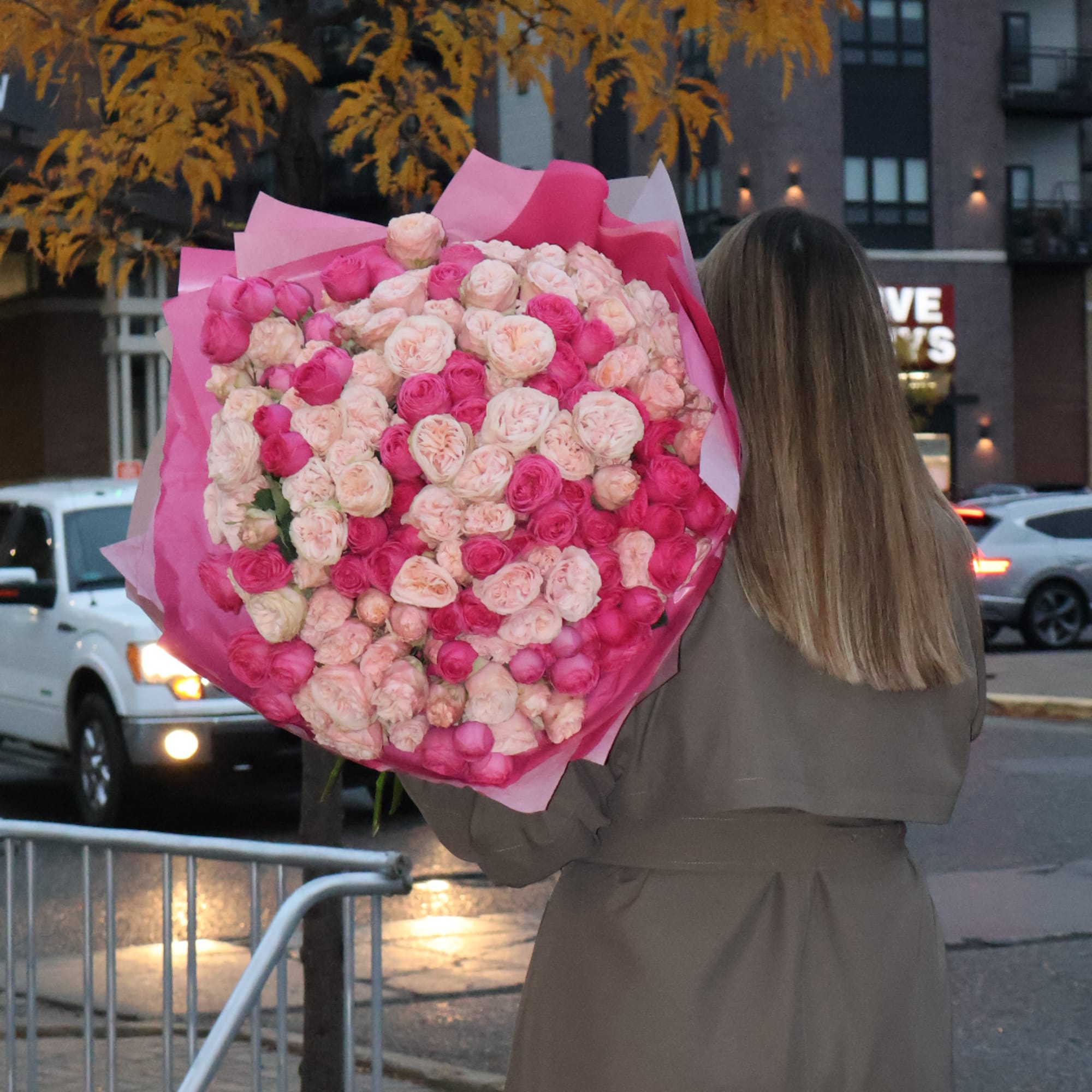 Large bouquet of pink and blush roses wrapped in bright pink paper, photo 4 of 5