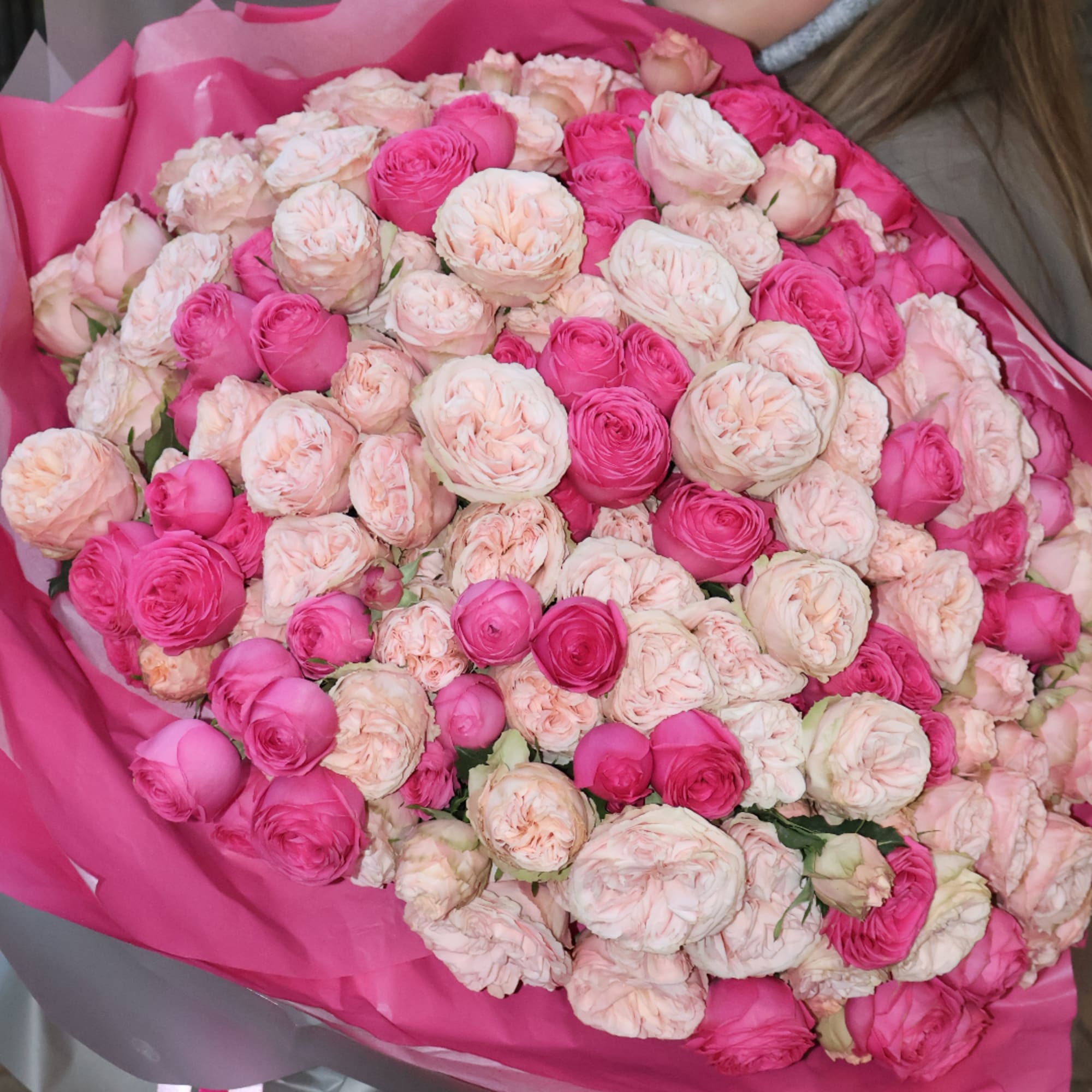 Large bouquet of pink and blush roses wrapped in bright pink paper, photo 5 of 5