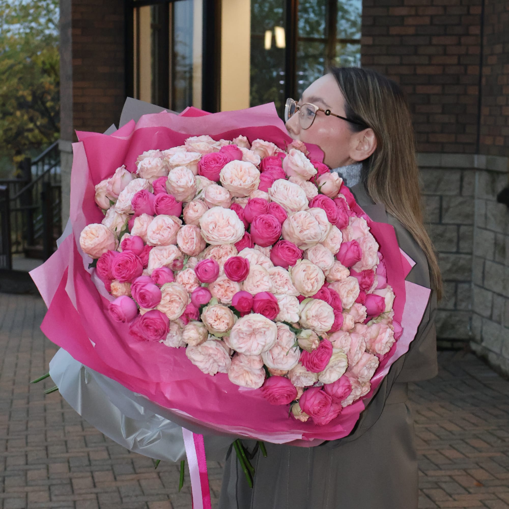 Large bouquet of pink and blush roses wrapped in bright pink paper, photo 3 of 5