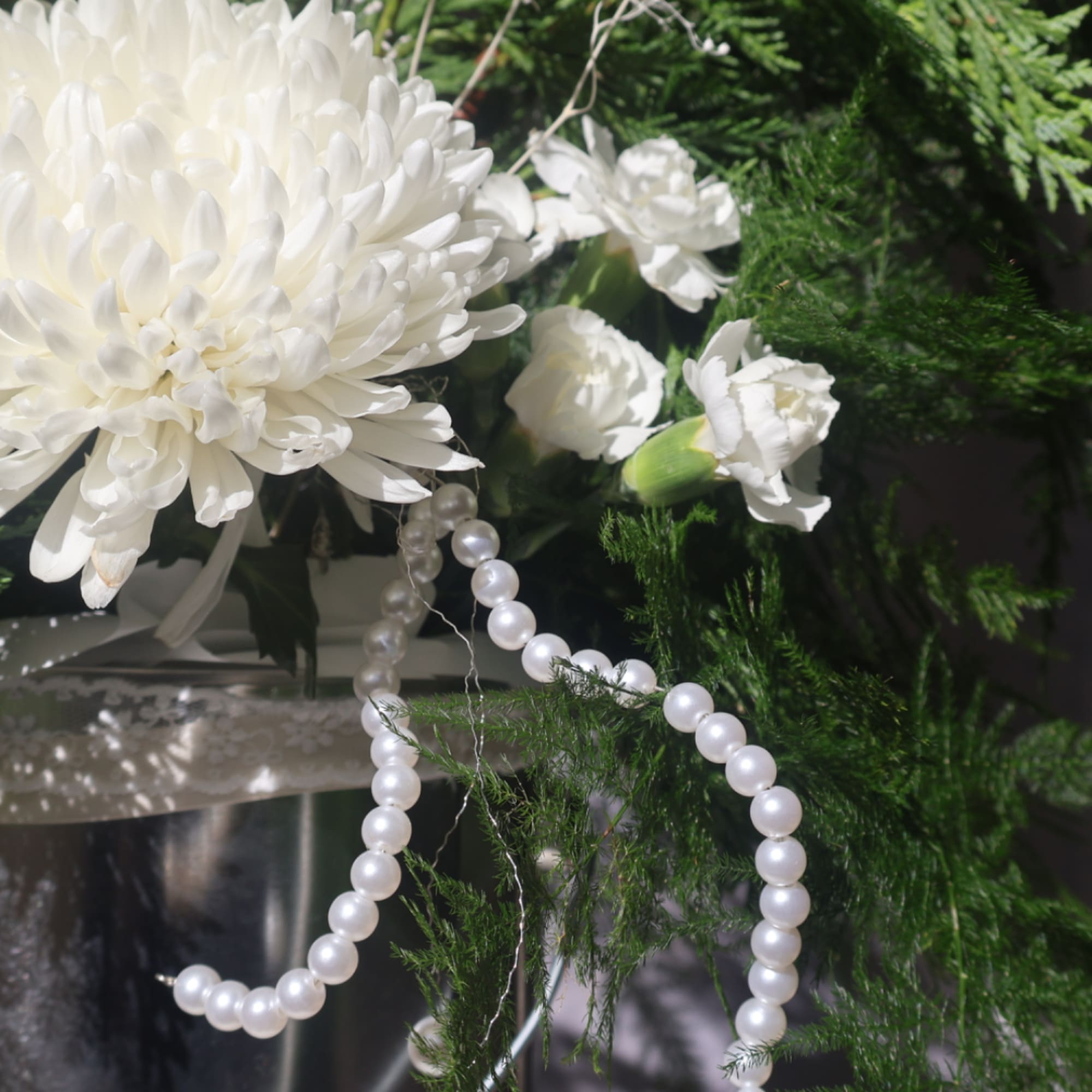 White chrysanthemum bouquet with small white carnations and pearl strands