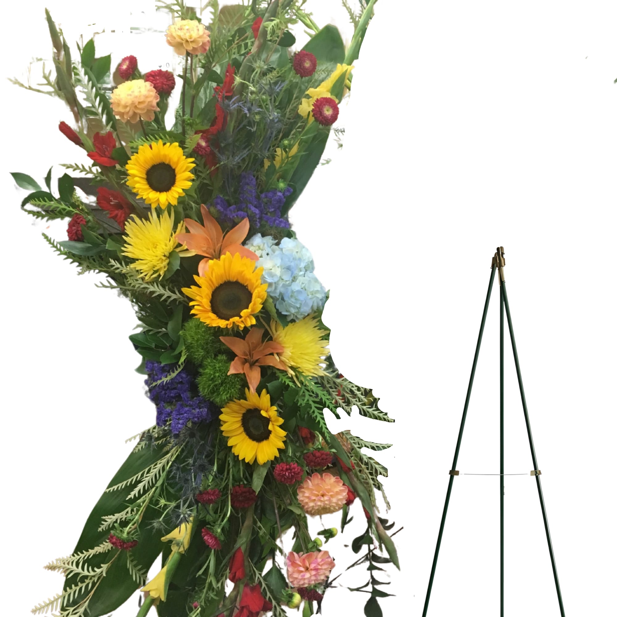 Tall floral standing spray with sunflowers, hydrangea, and mixed blooms on an easel