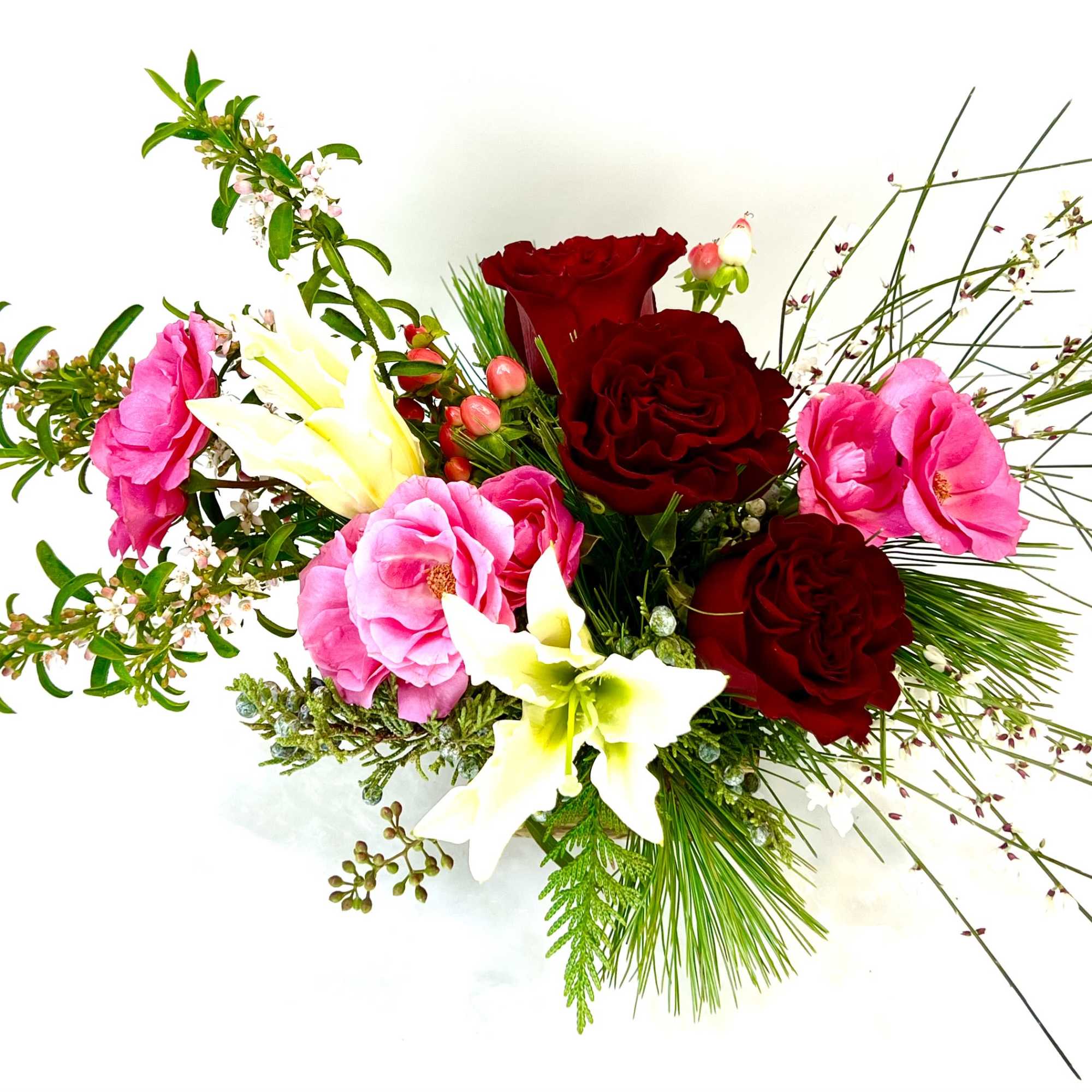 Bouquet of red and pink roses with white lilies and greenery