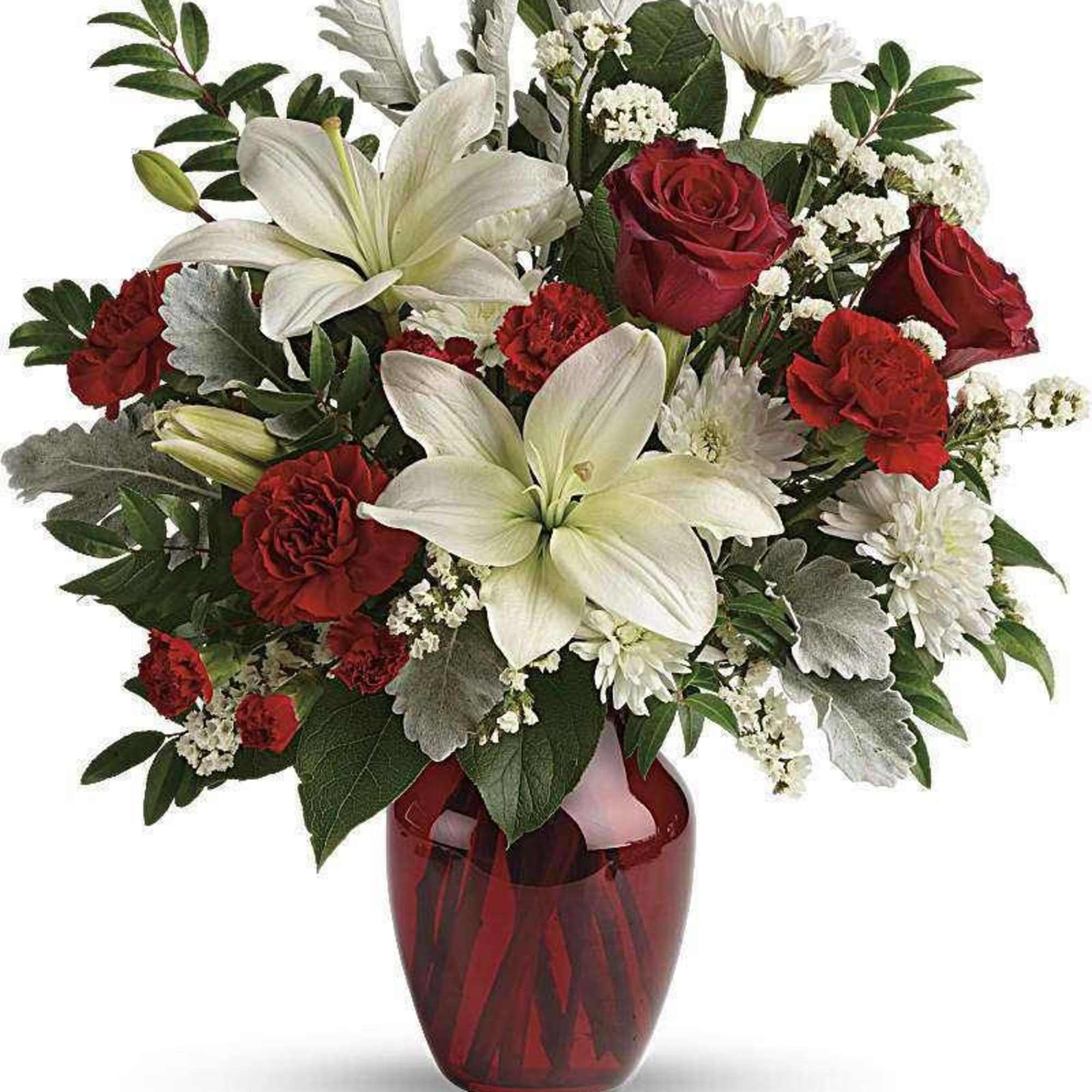 Red and white floral arrangement in a red glass vase
