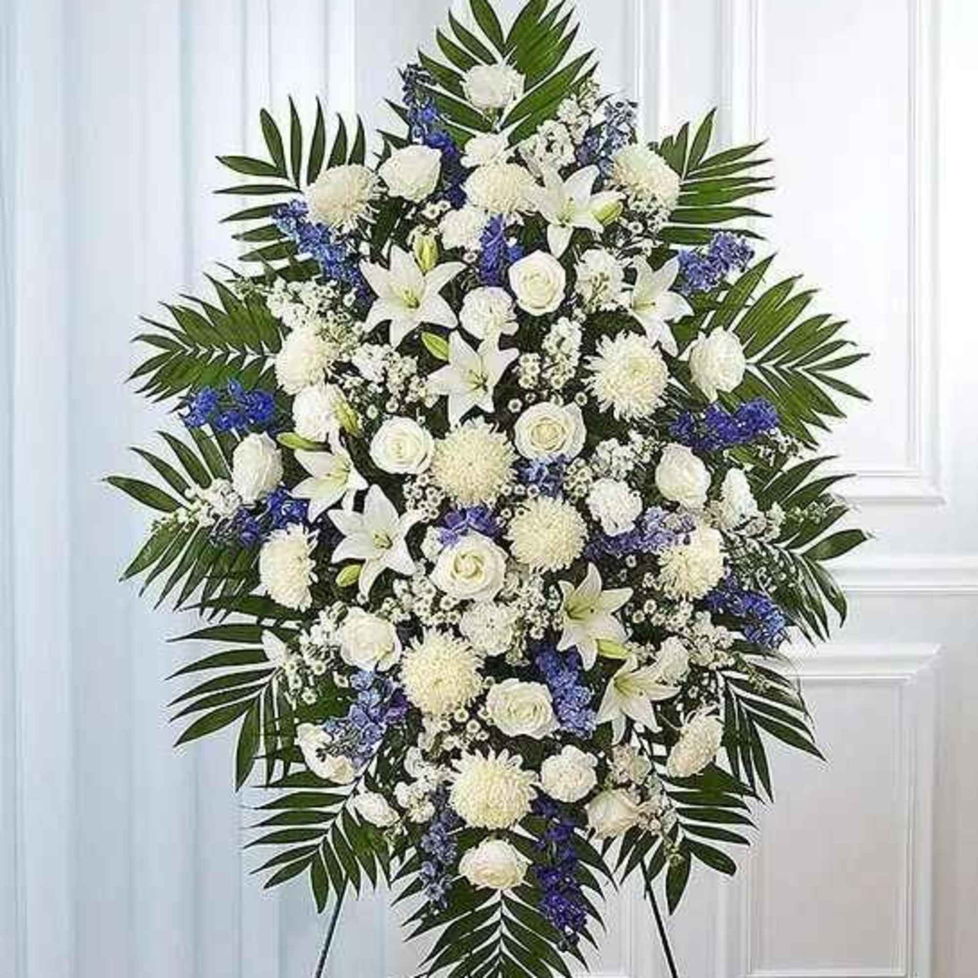 Large white and blue funeral spray with palm fronds