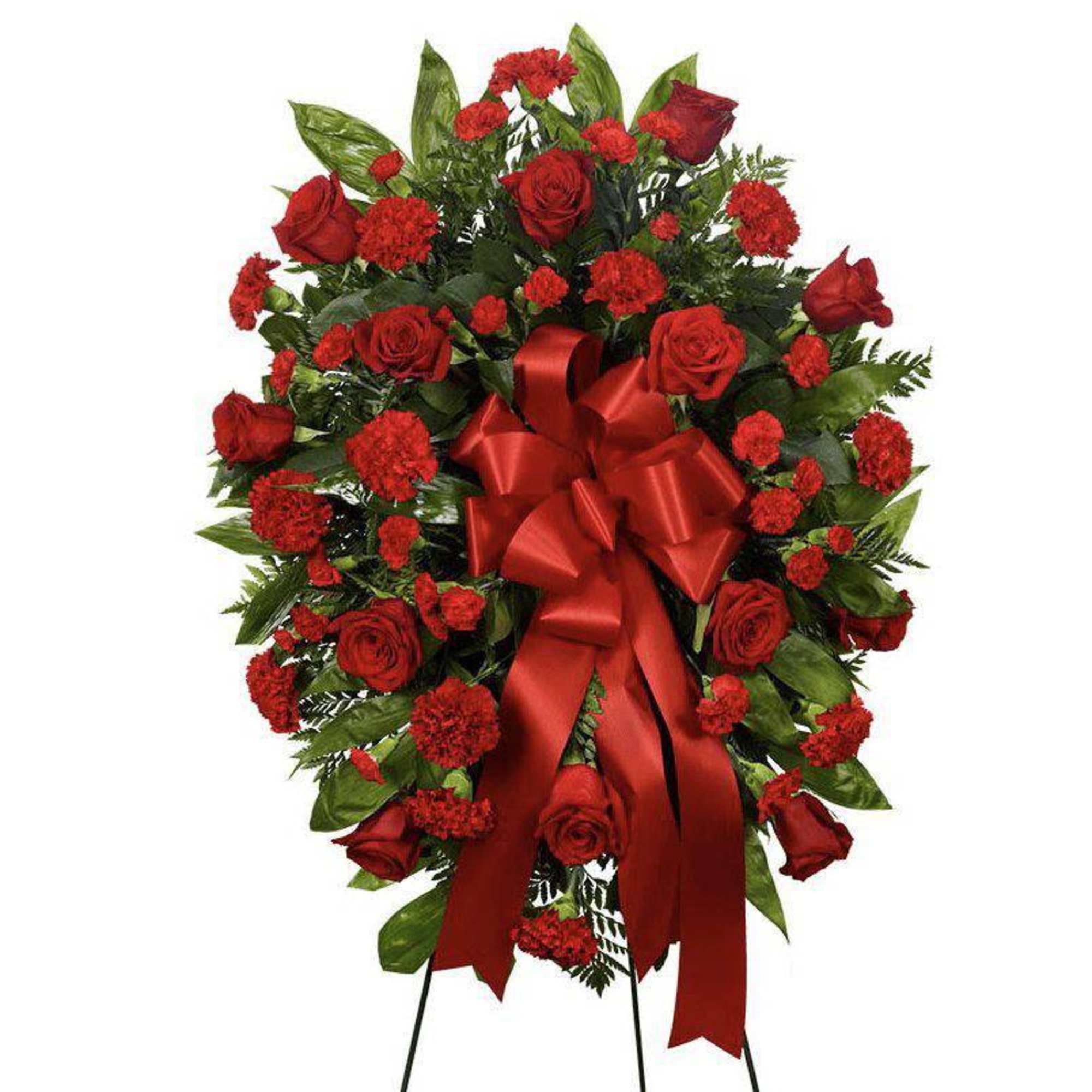 Red rose and carnation standing spray with a large red ribbon