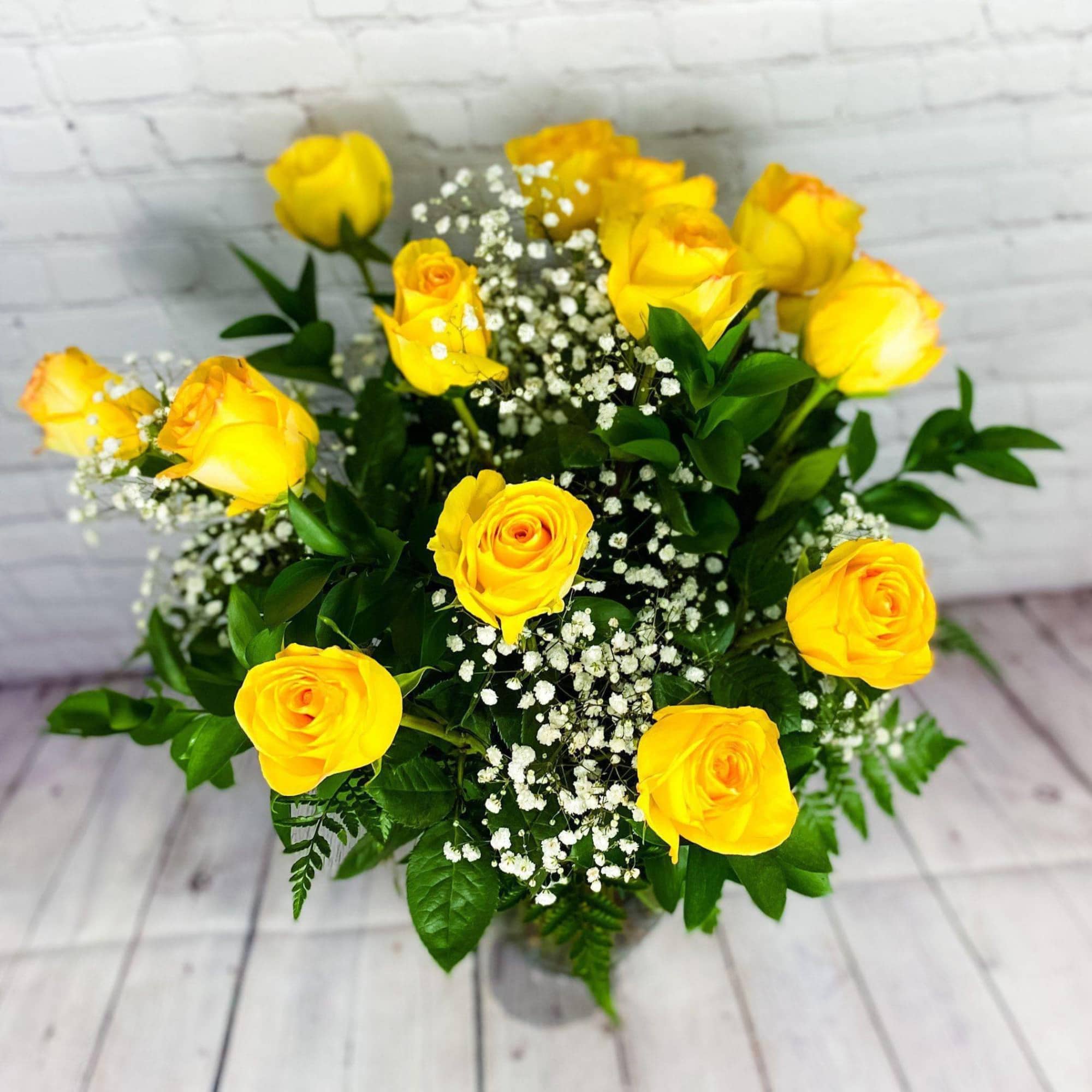 Yellow roses with white baby's breath in a bouquet