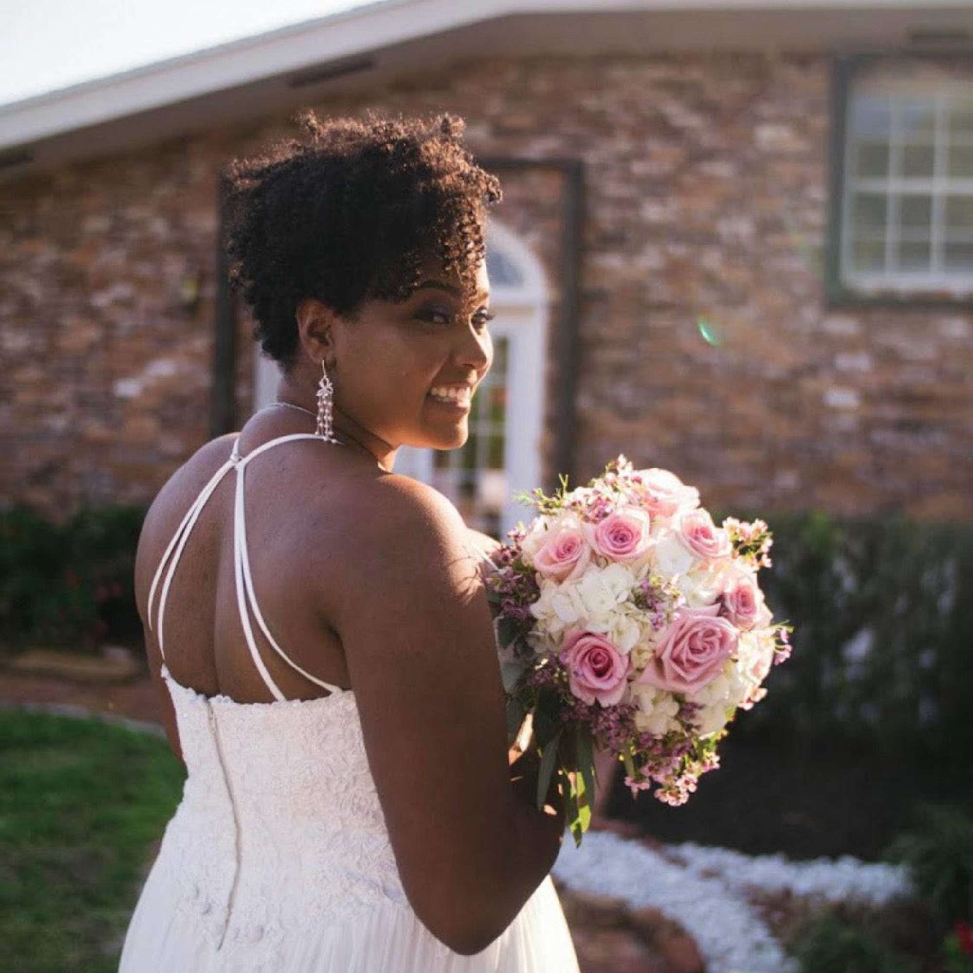 Bride holding a bouquet of pink and white roses