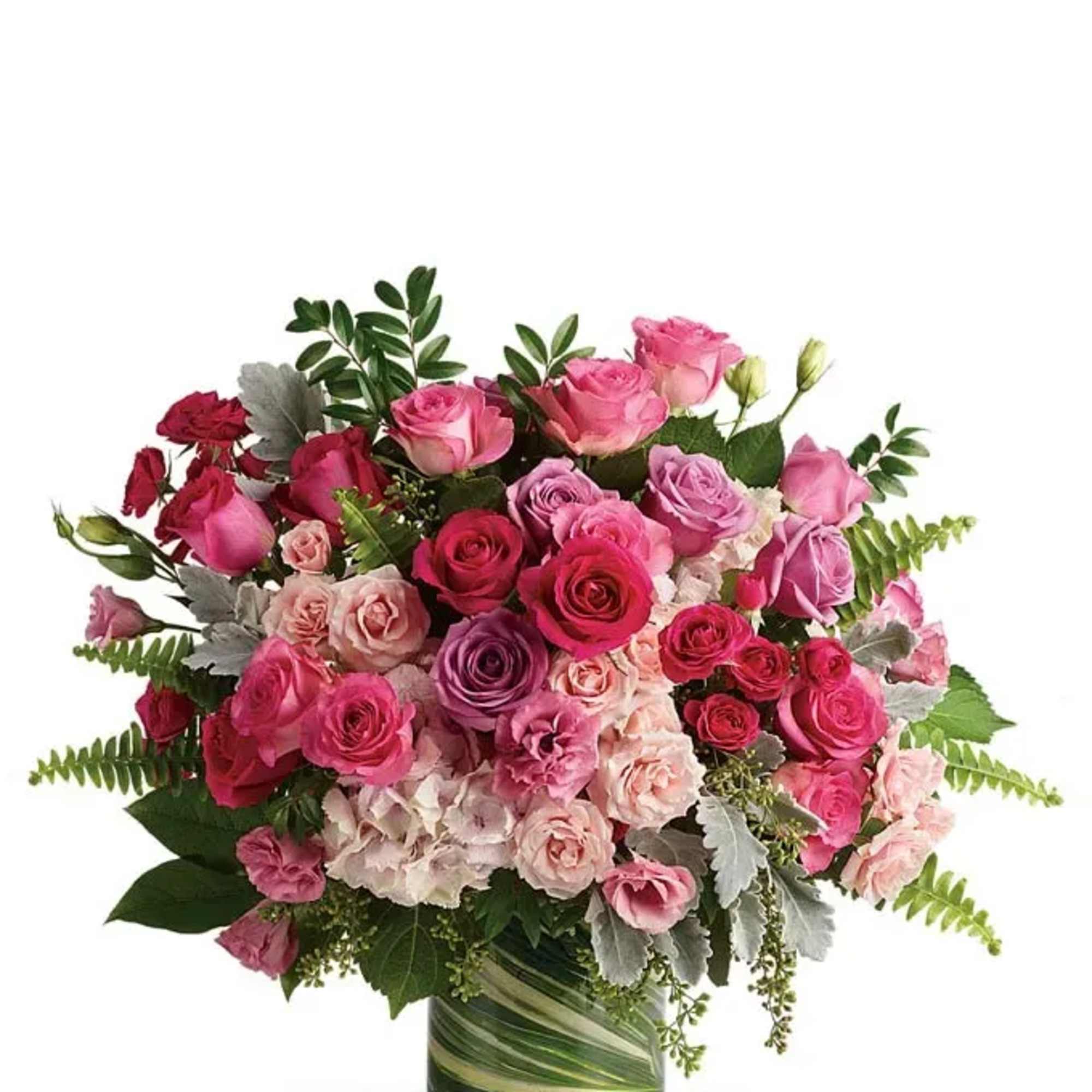 Pink and red roses arranged in a glass vase