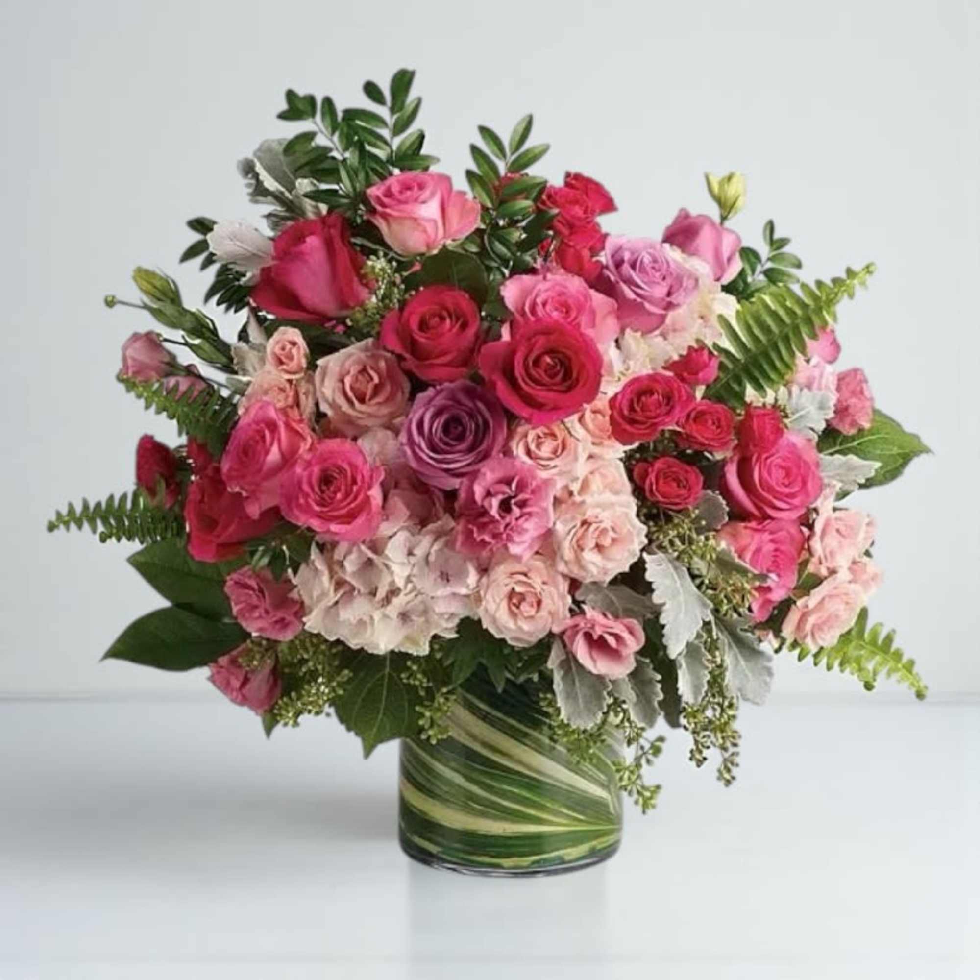 Pink and red rose bouquet in a glass vase