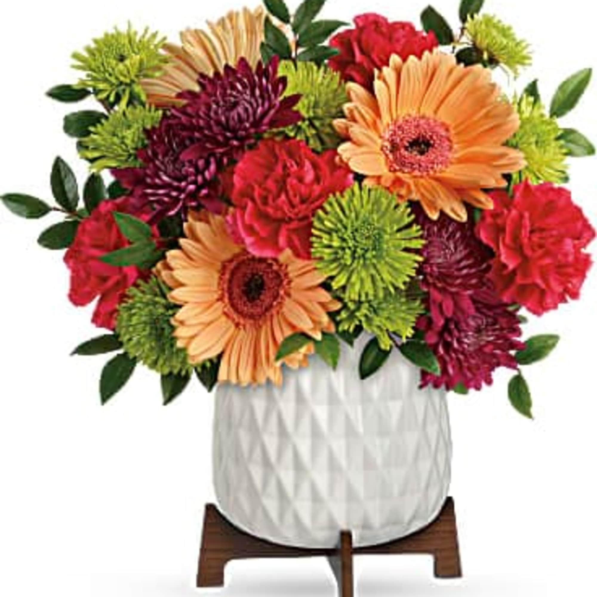 Mixed bouquet of gerbera daisies and chrysanthemums in a white vase
