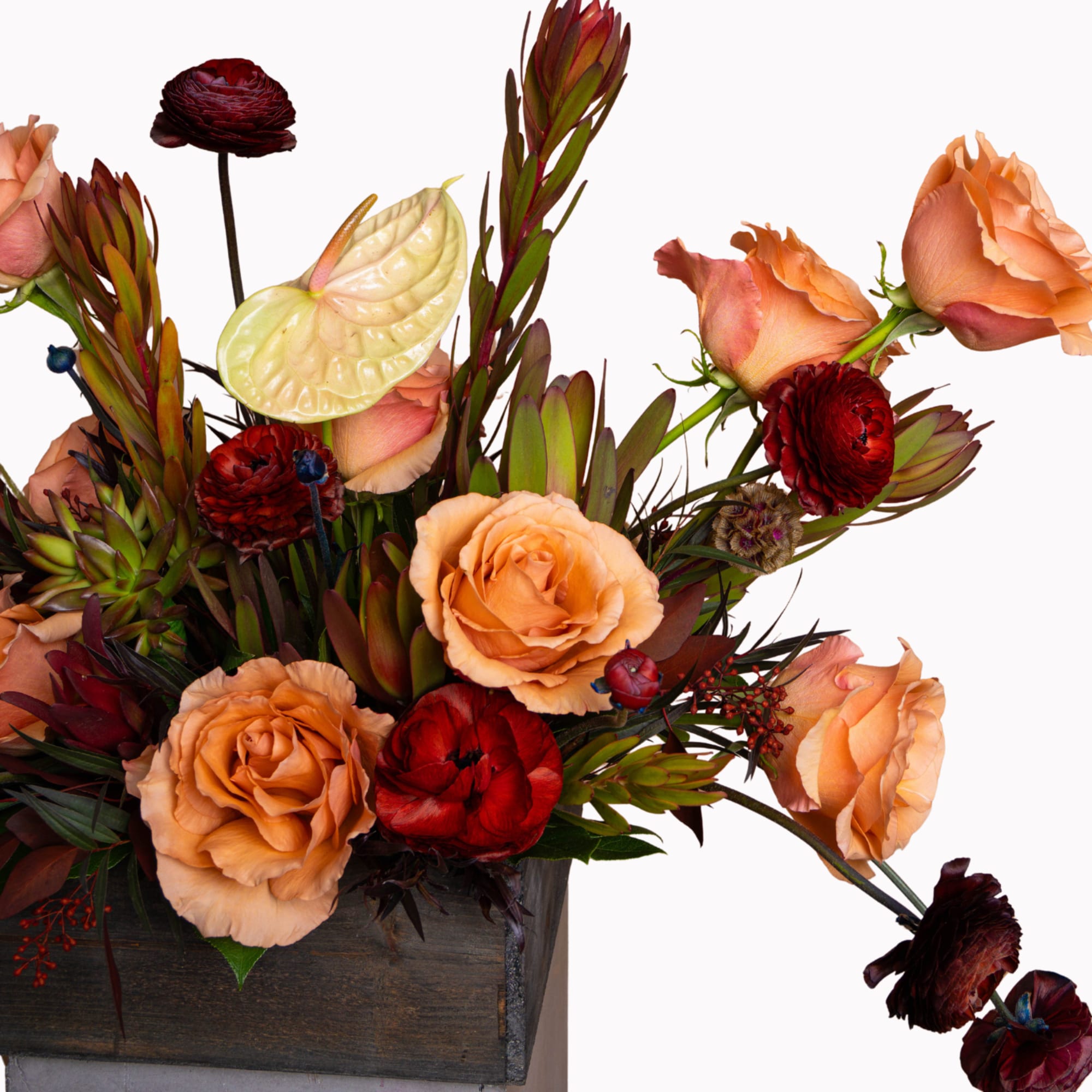 Peach and red roses with anthurium in a wooden box