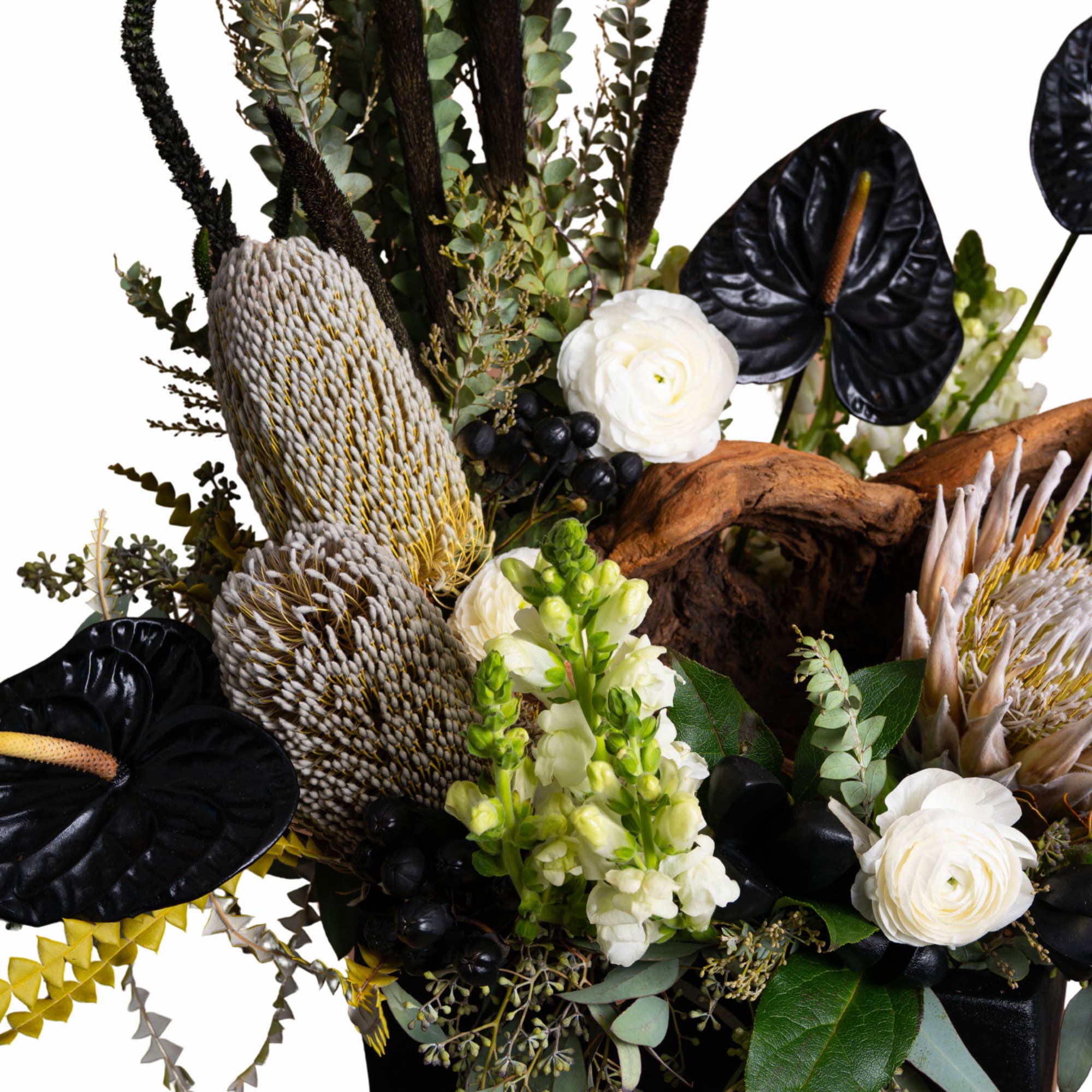 Arrangement with white blooms, black anthuriums, and textured seed pods