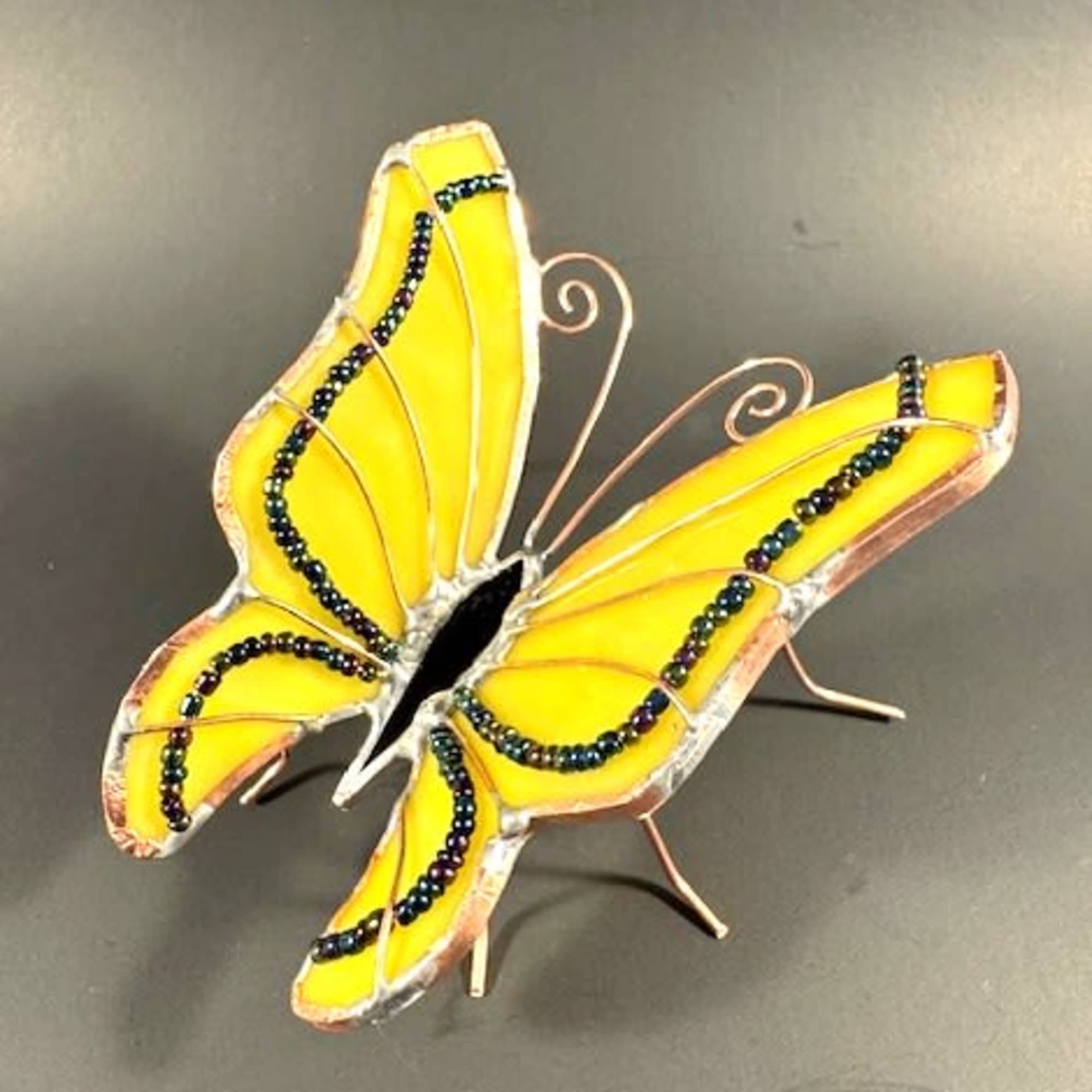 A bright yellow stained-glass butterfly catches the eye first - perfect as