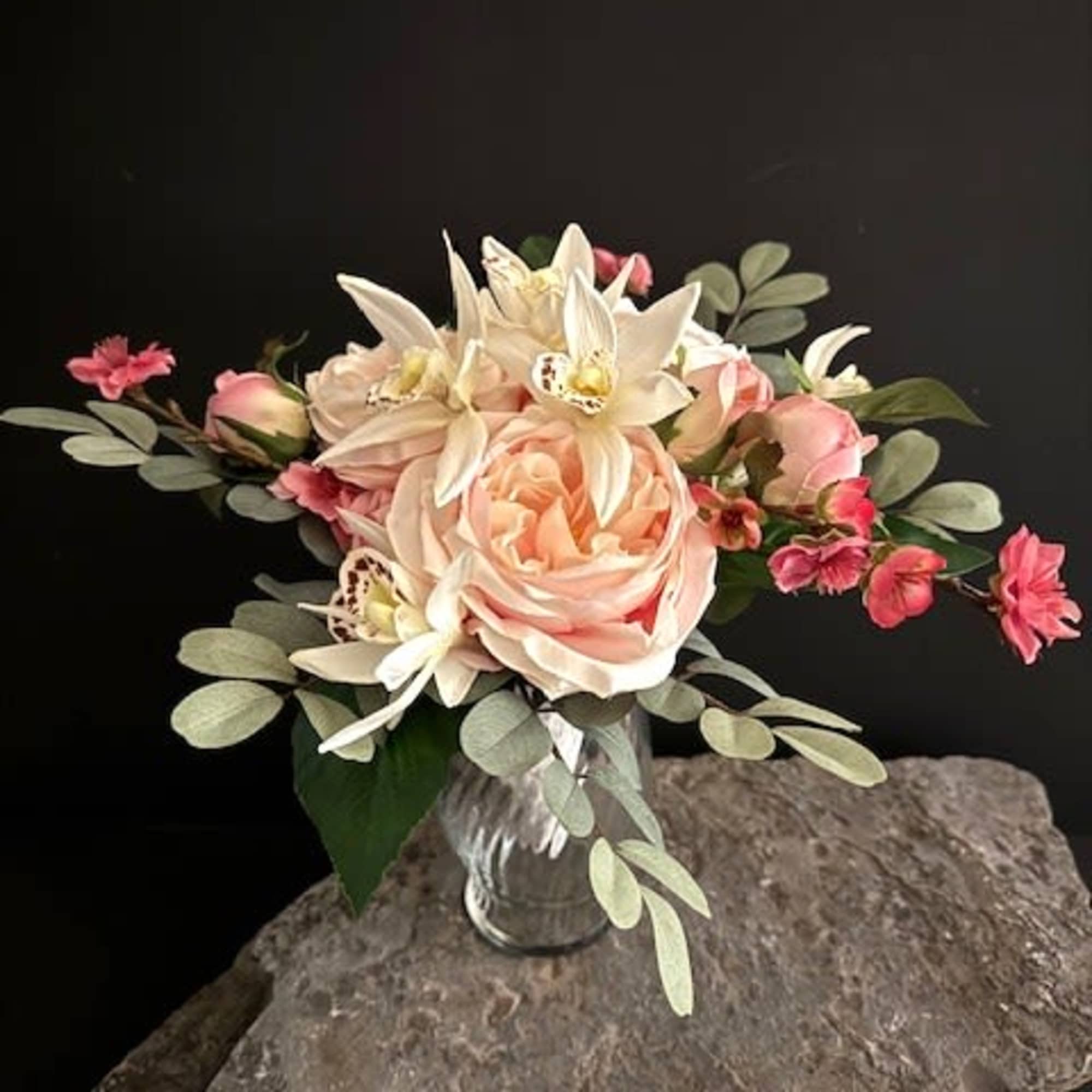 A single lush peach cabbage rose sits at the heart of this