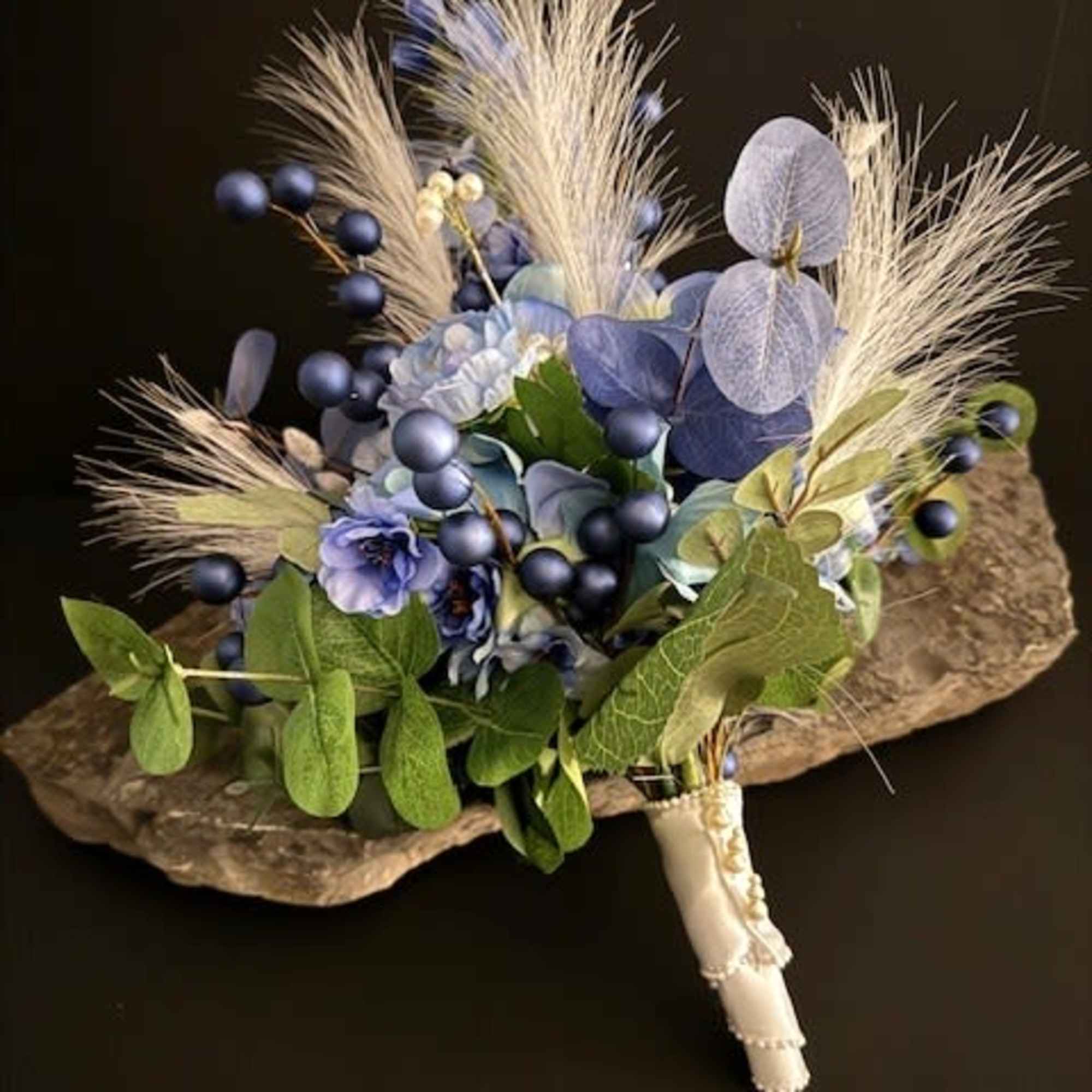 Soft blue hydrangeas and velvety ranunculas form the heart of this silk